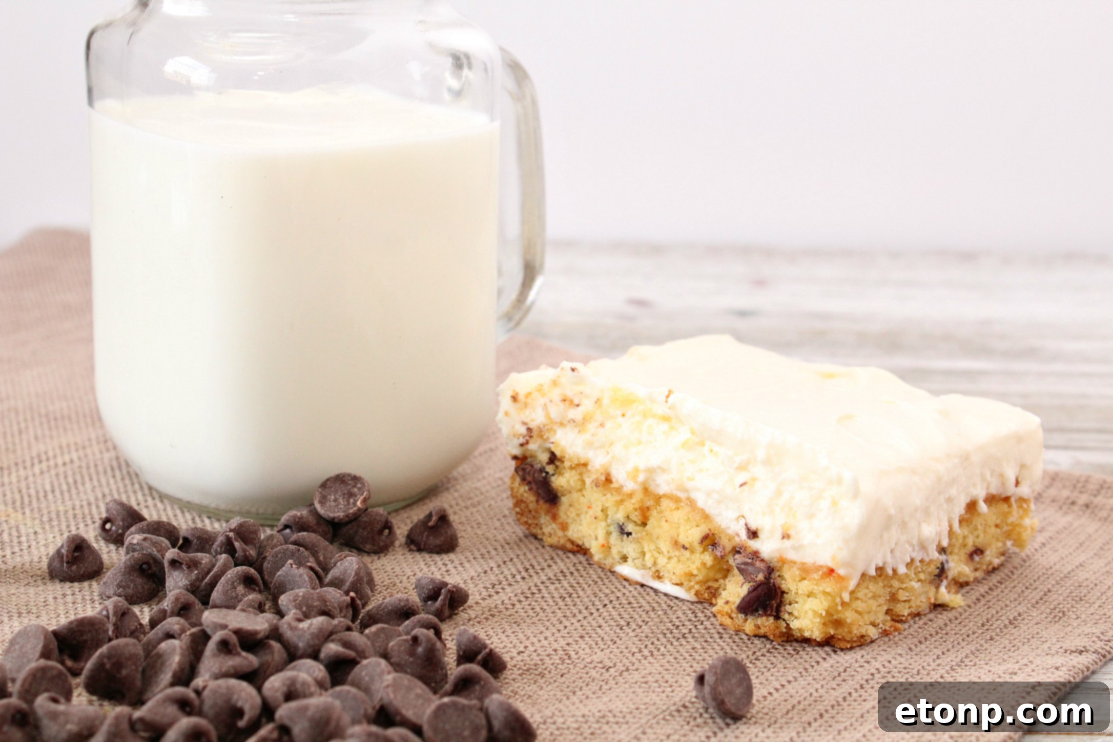 A tray of freshly baked Toll House Chocolate Chip Cheesecake Bars, glistening and ready to cool