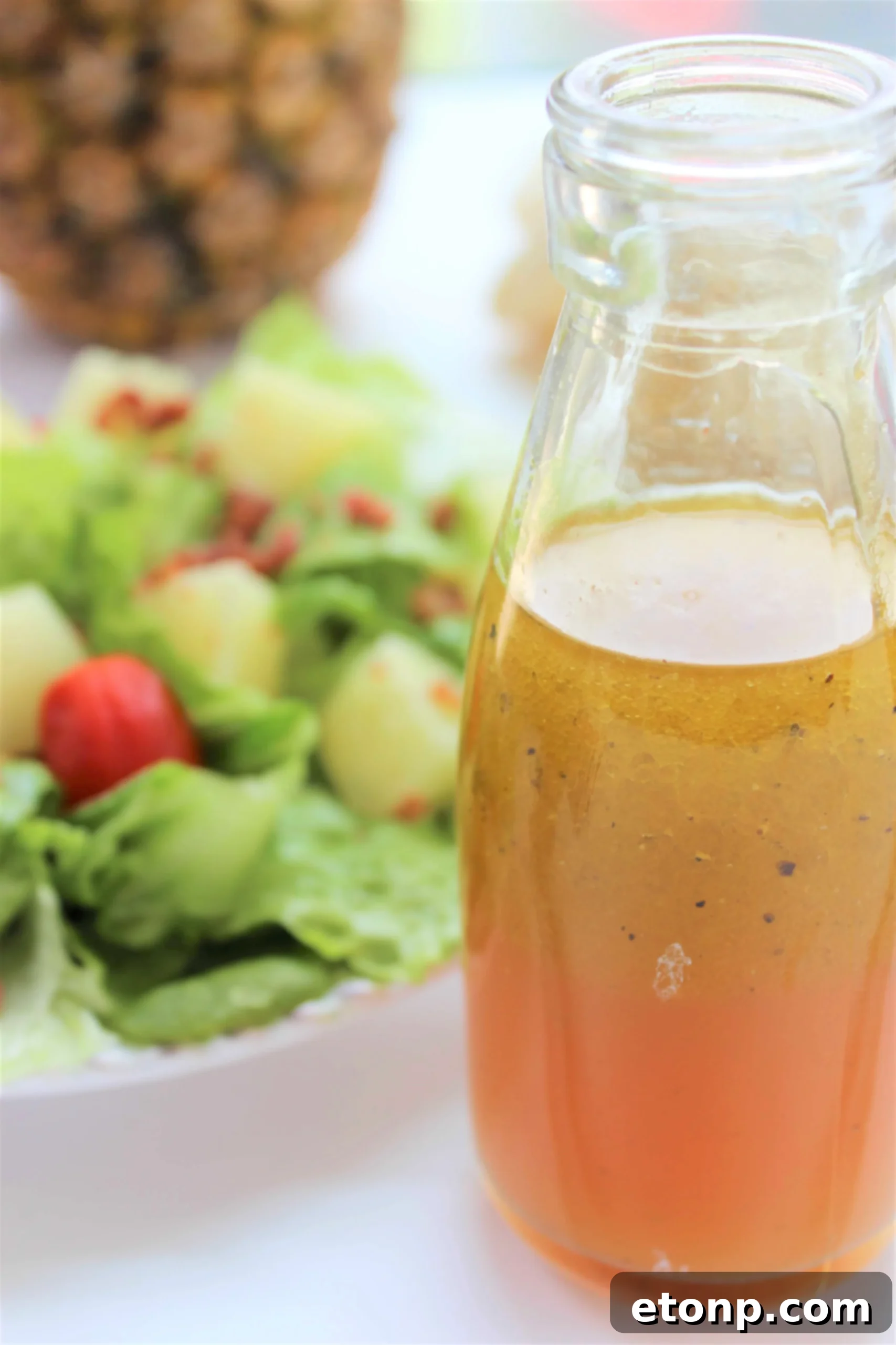 Homemade Pineapple Vinaigrette in a glass jar with fresh pineapple