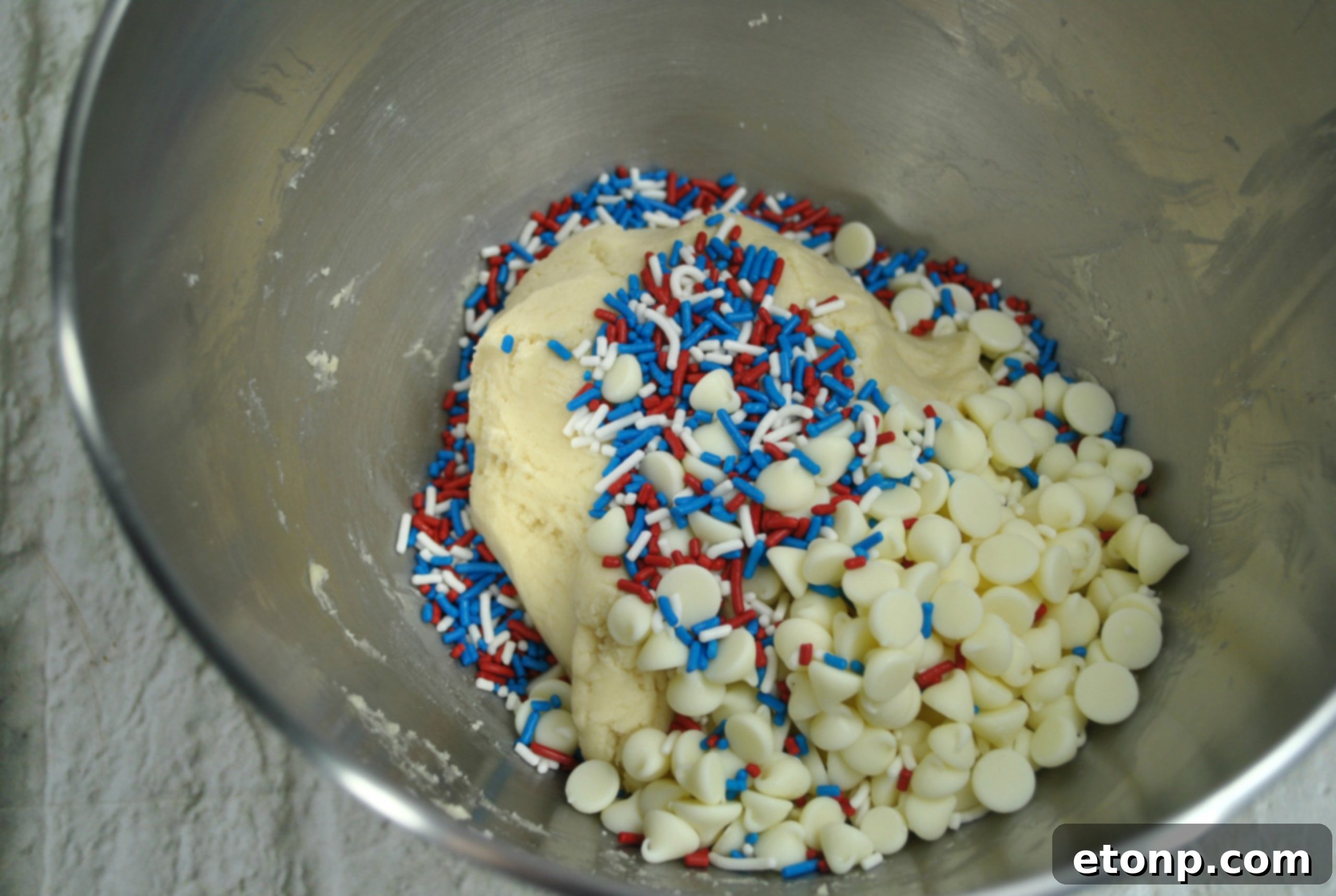 A plate stacked high with patriotic White Chocolate Firework Cookies, ready to be served.