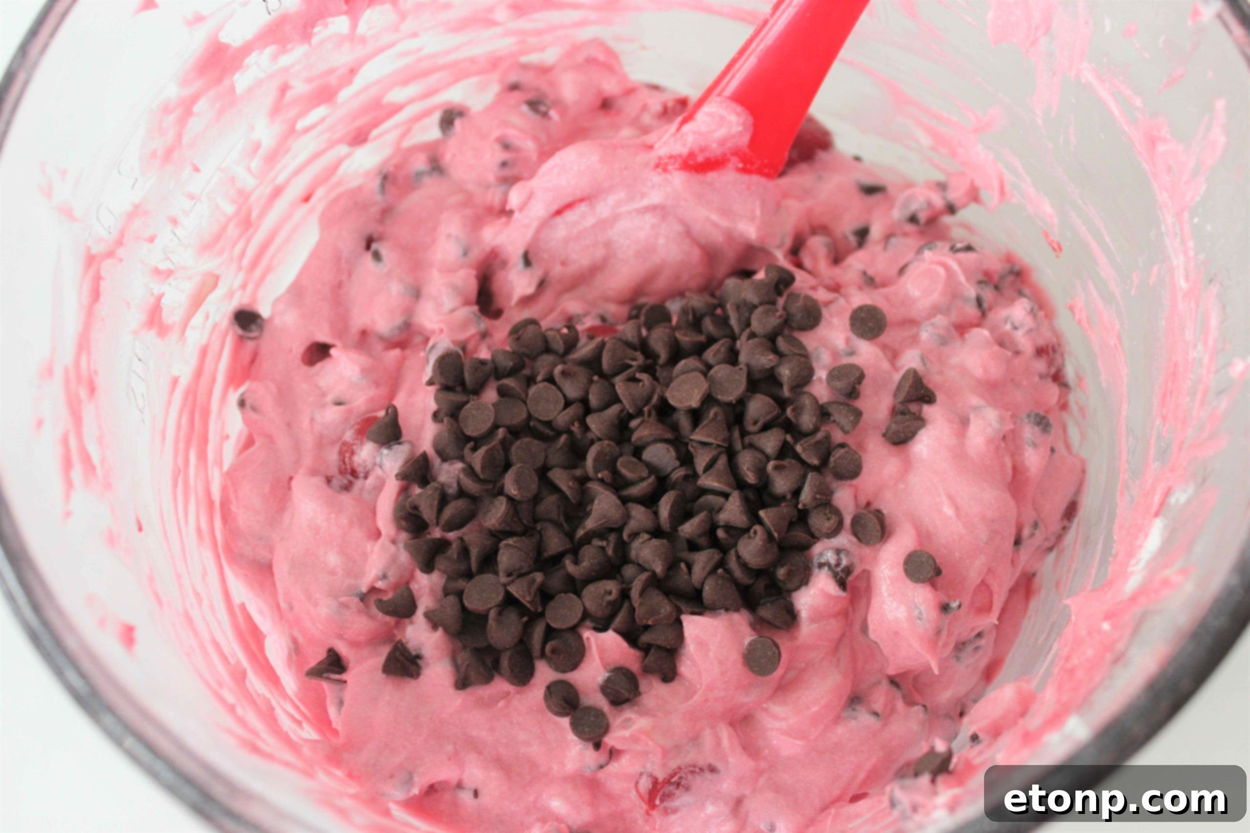 Top-down view of a No-Bake Cherry Chocolate Chip Dreamsicle Pie, showing its rich red cherry filling and chocolate cookie crust.