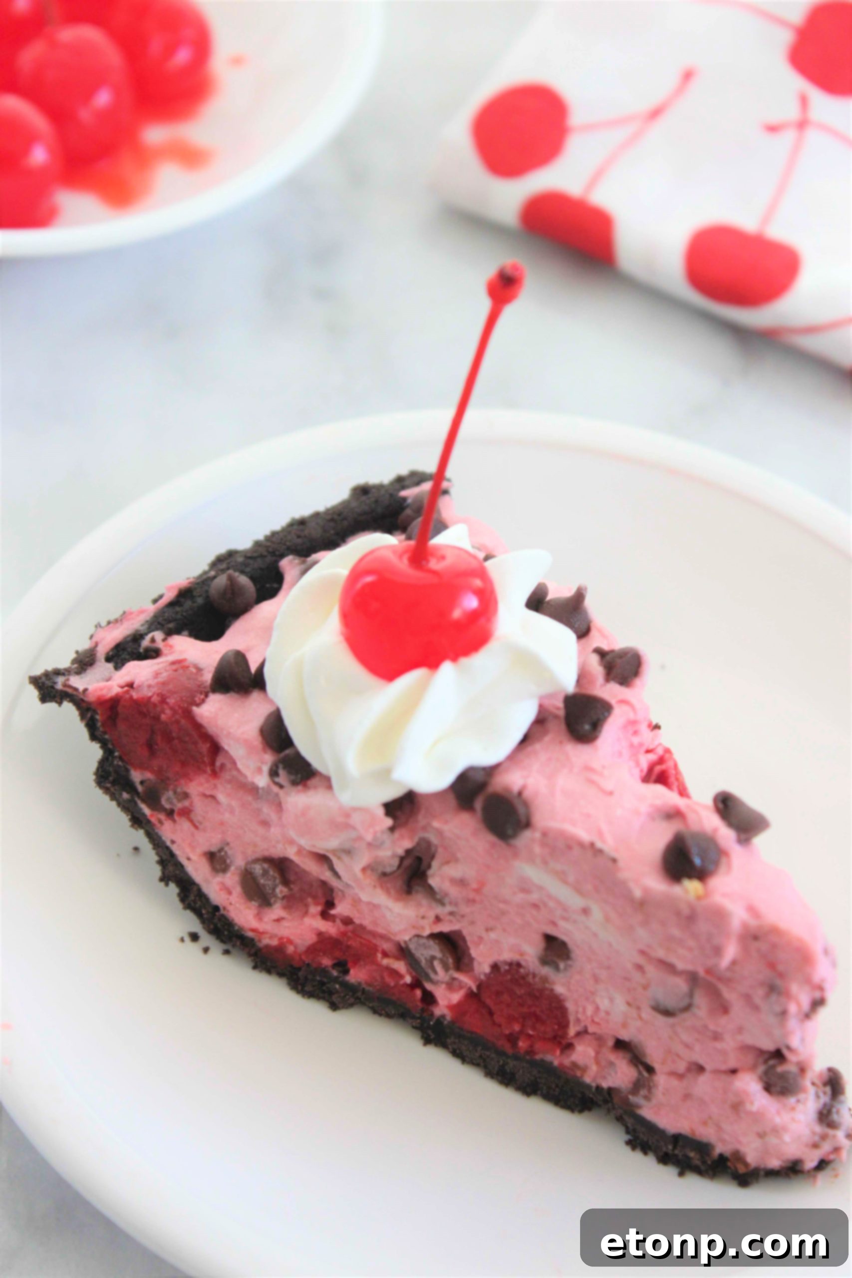 The No-Bake Cherry Chocolate Chip Dreamsicle Pie presented whole on a serving dish, highlighting its visual appeal.