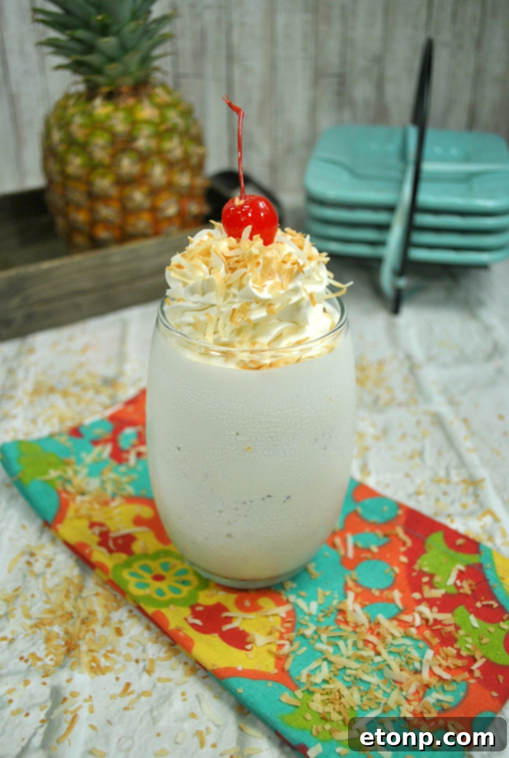 Pina Colada Cocktail 3 Two vibrant Pina Colada cocktails, one with a pineapple wedge and cherry garnish, set against a blurred background, evoking a tropical vacation.