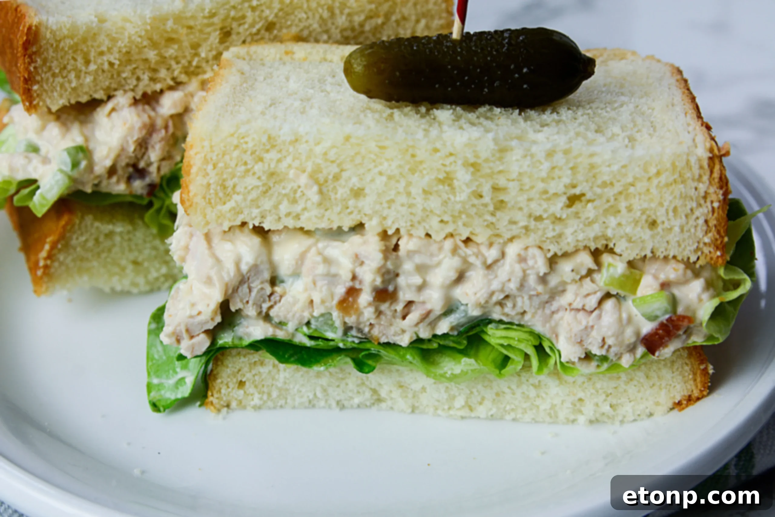 The Ultimate Chicken Salad 5 Ingredients for chicken salad, including a whole rotisserie chicken, mayonnaise, celery, and herbs.