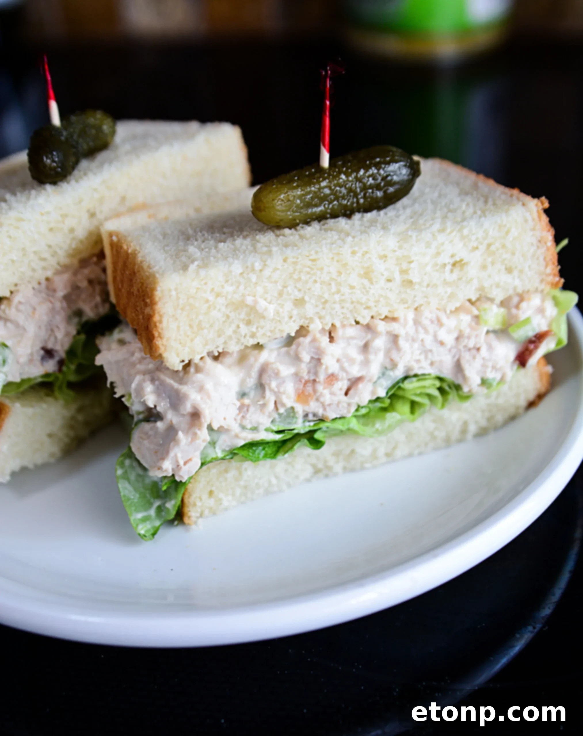 The Ultimate Chicken Salad 6 A bowl of chicken salad with a scoop on a piece of toasted bread, ready to eat.