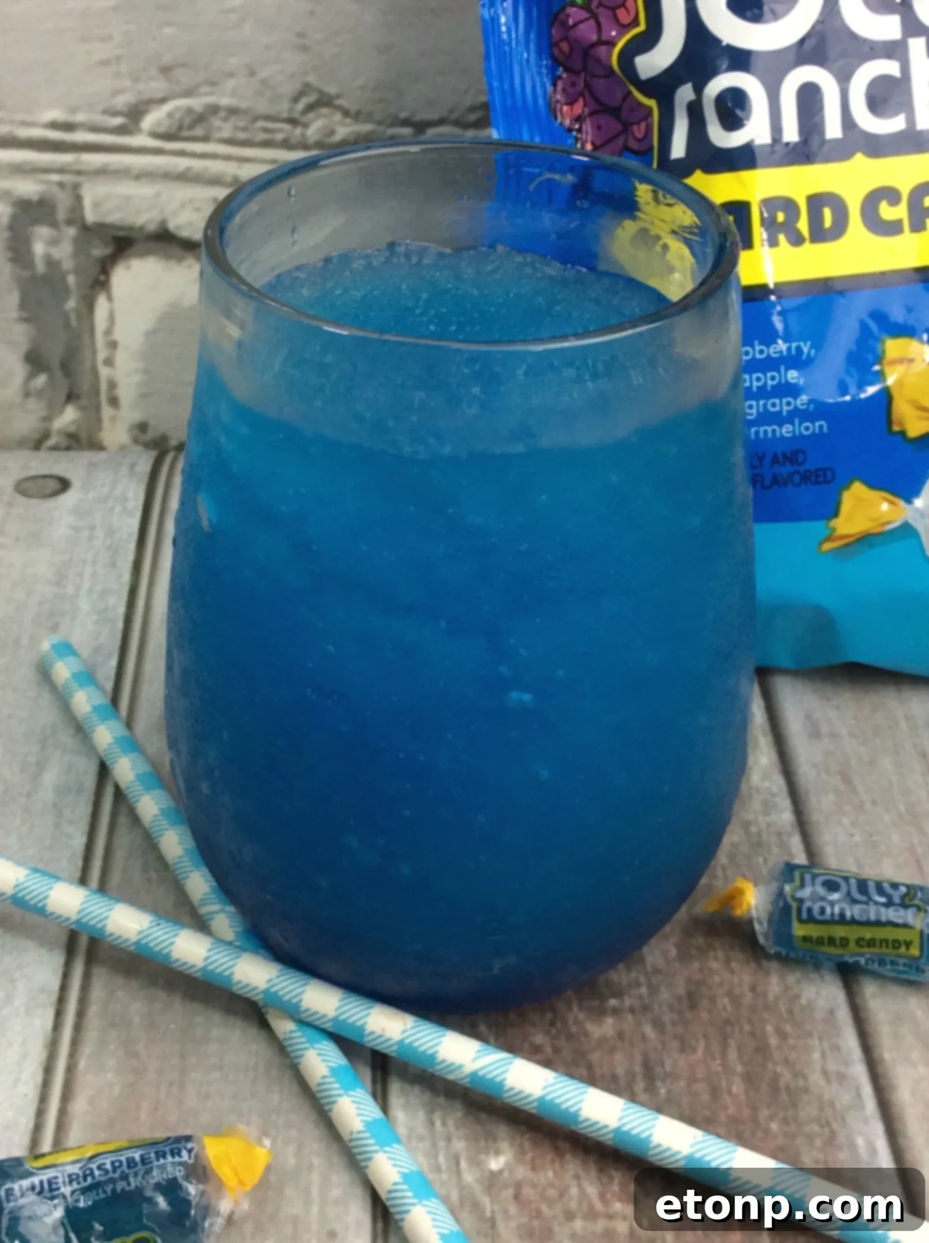 A freshly blended Blue Raspberry Jolly Rancher Slushy Cocktail in a festive glass.