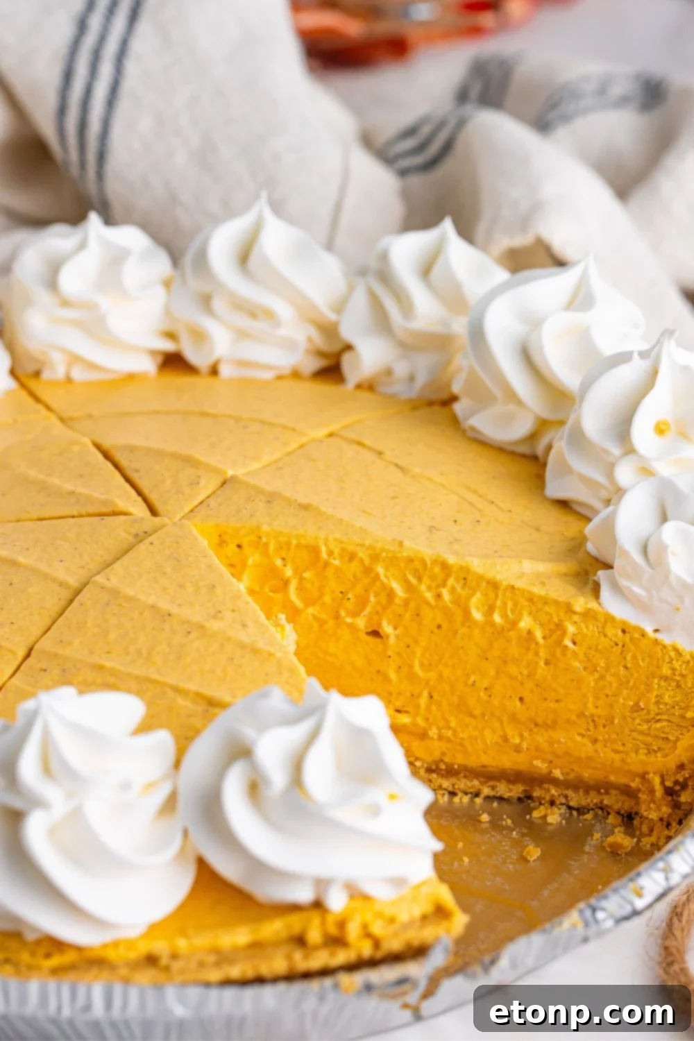 pumpkin spice cheesecake with slice taken out of pan