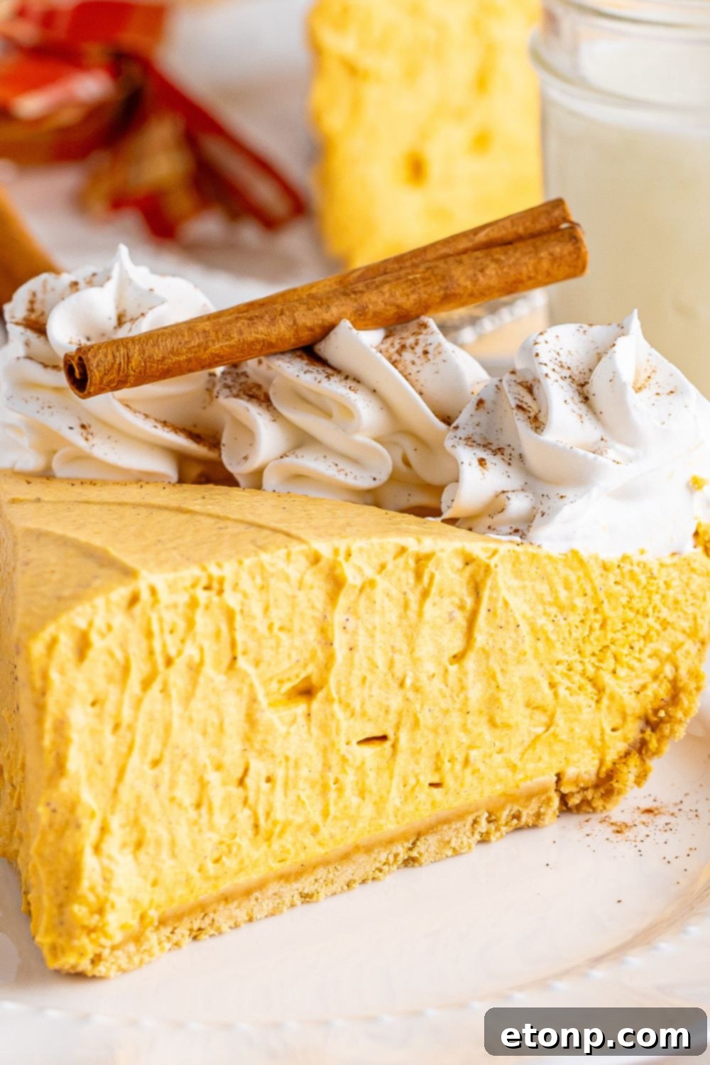 pumpkin spice cheesecake sliced on plate
