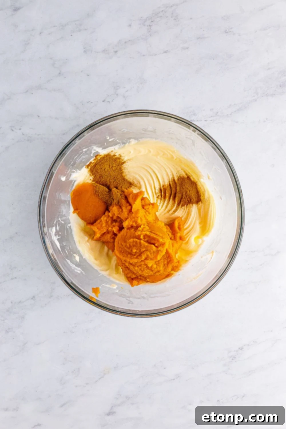 cheesecake batter filling in a glass bowl