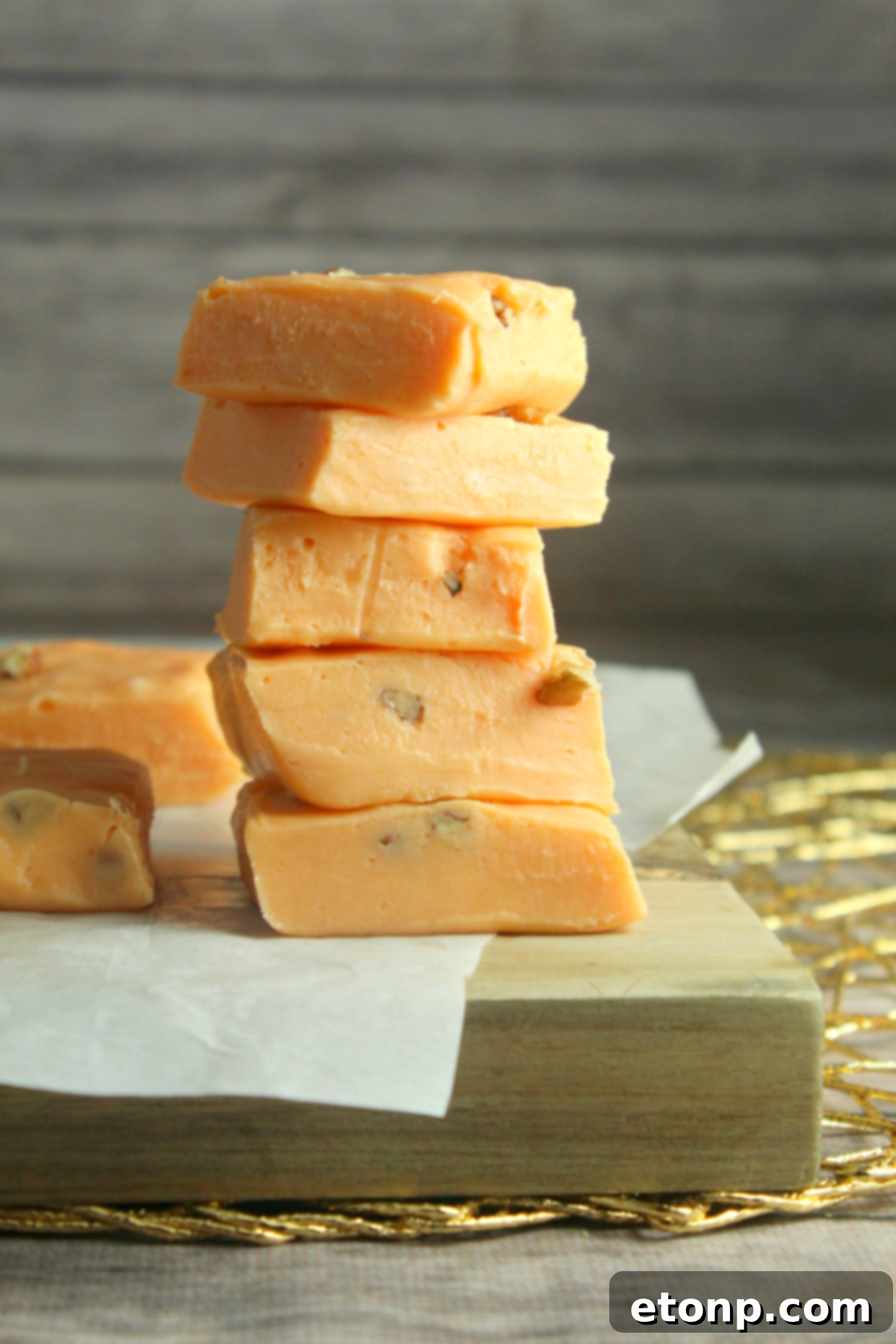 Individual squares of pumpkin fudge arranged beautifully on a serving plate