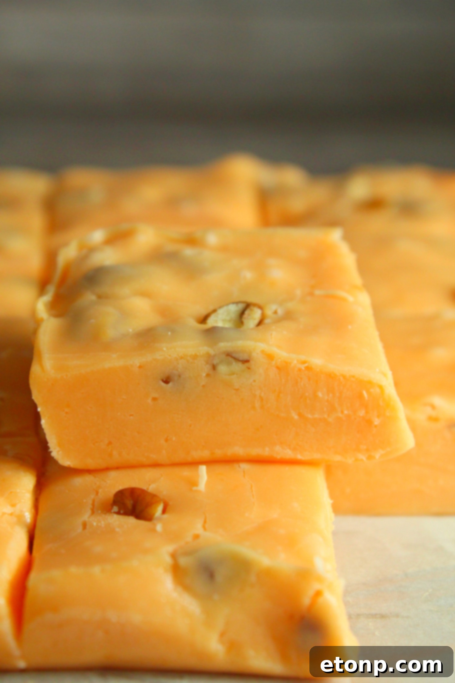 A close-up of soft, perfectly set pumpkin fudge, showcasing its smooth texture