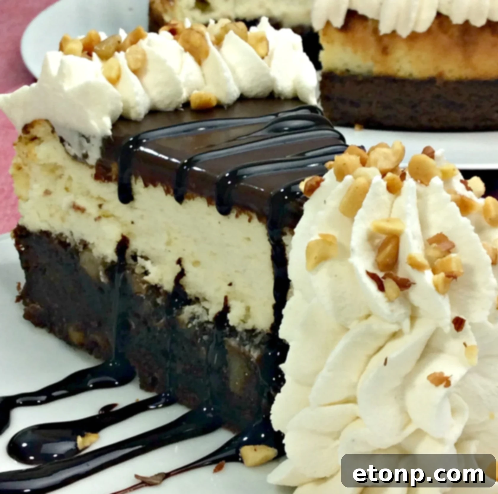 Beautifully layered Hot Fudge Sundae Brownie Cheesecake with chocolate ganache and whipped cream