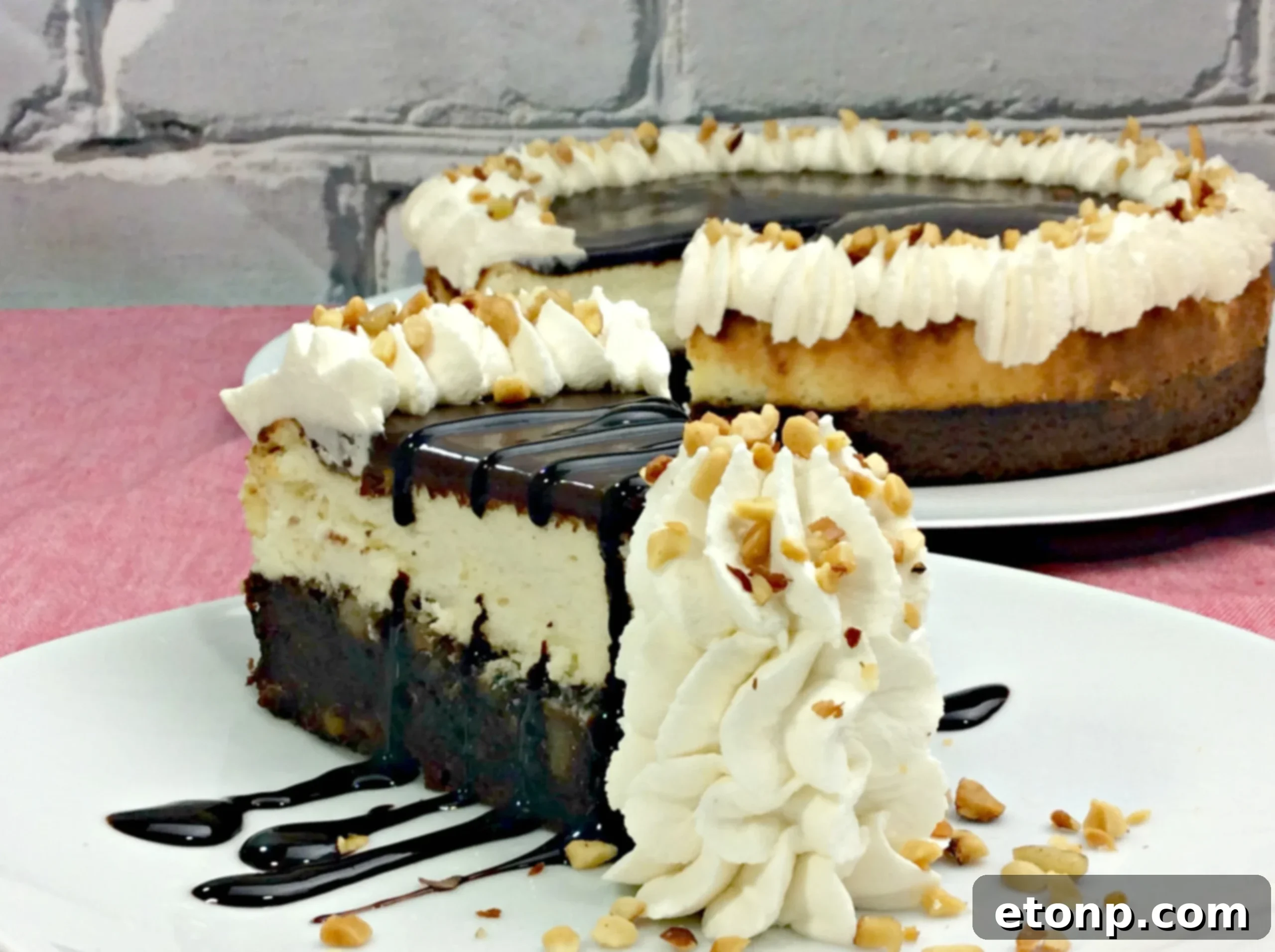 Close-up of a slice of Hot Fudge Sundae Brownie Cheesecake, showing the distinct layers