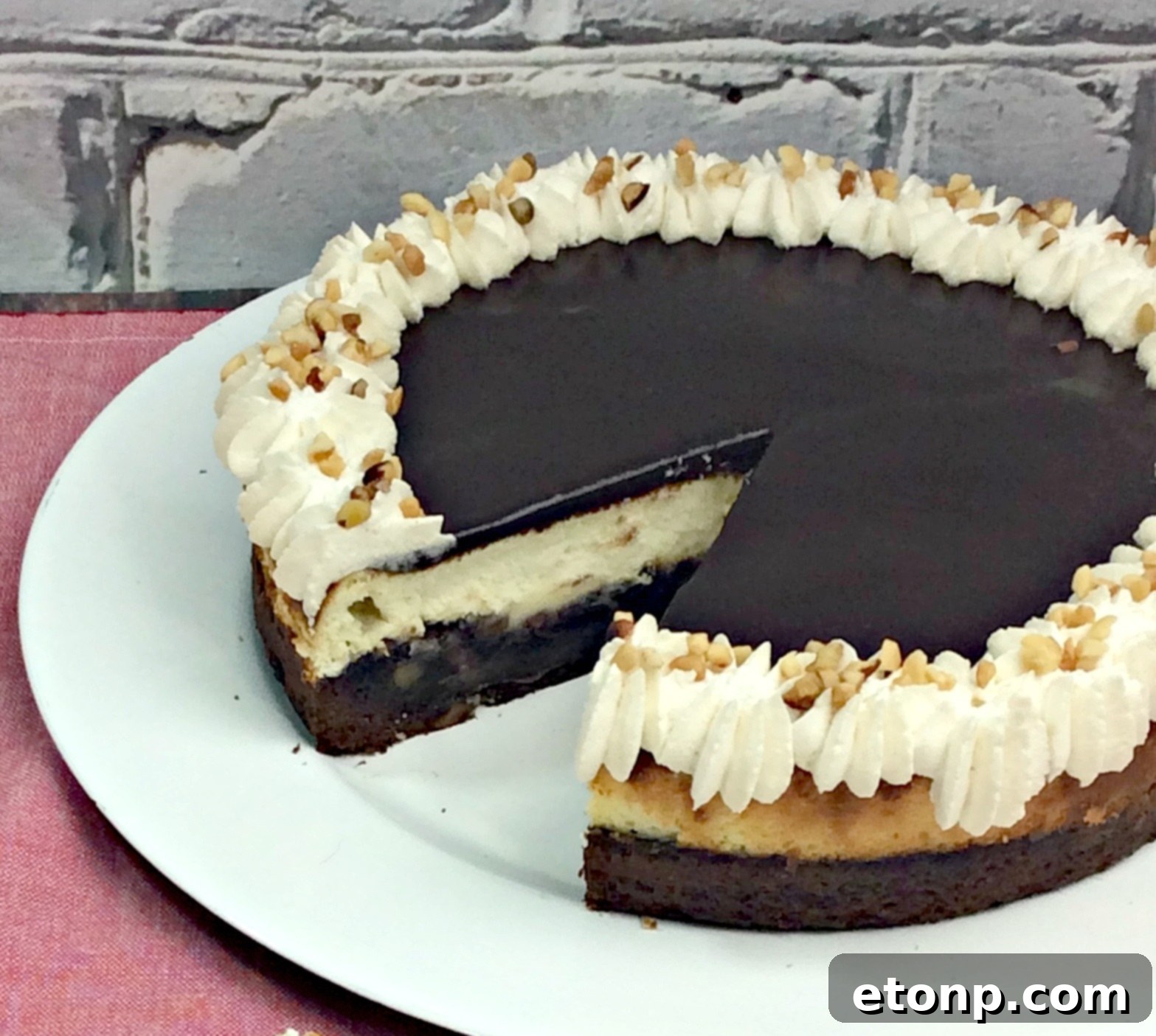 Side view of the multi-layered Hot Fudge Sundae Brownie Cheesecake, highlighting its height and elegance