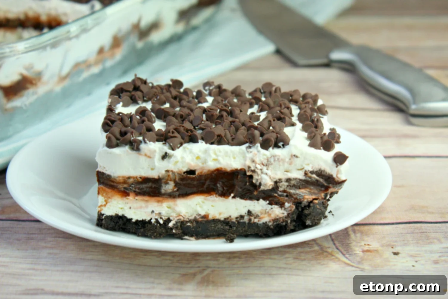 Close-up of the smooth, light-colored cream cheese layer in the No-Bake Chocolate Lasagna.