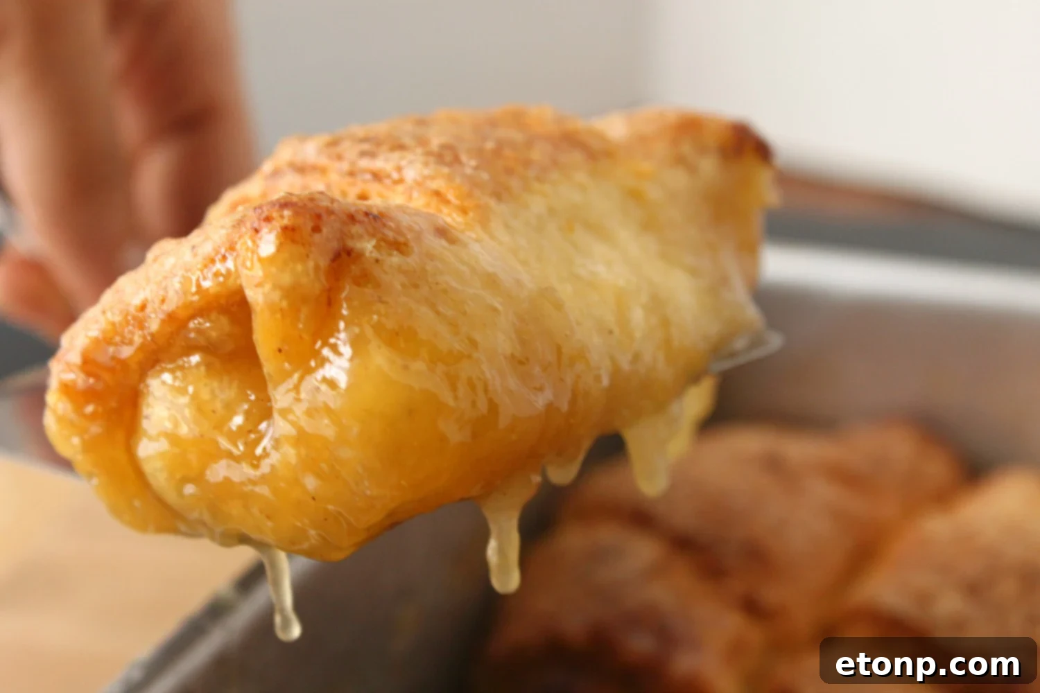 Golden-brown peach dumplings, fresh from the oven, filling the kitchen with their sweet aroma.