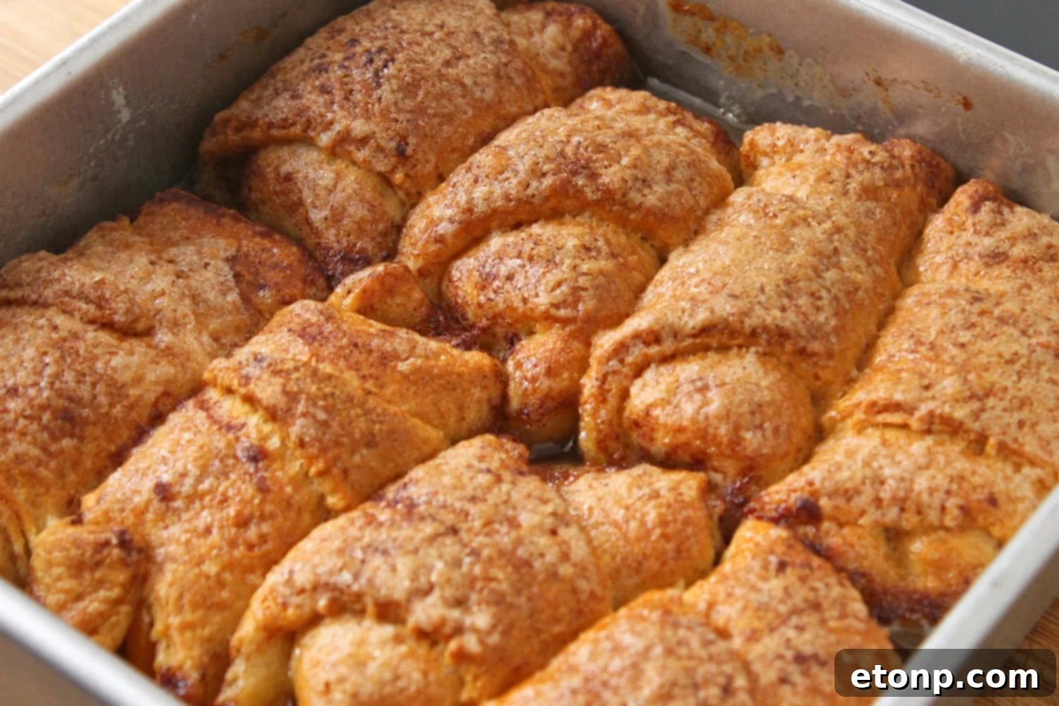 A closer view of the raw peach dumplings in the dish, ready for the sweet, buttery sauce.