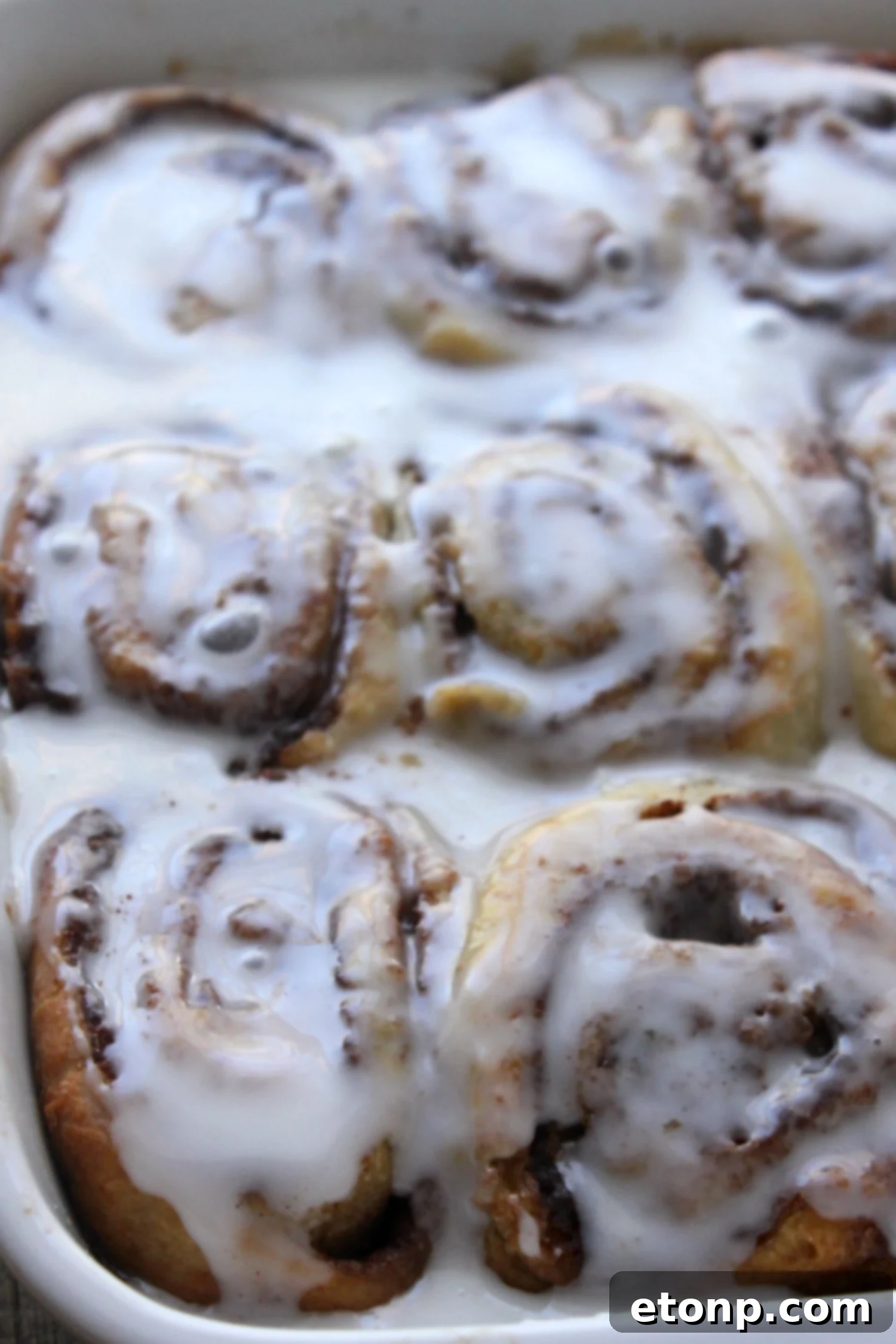 45 Minute Cinnamon Roll Magic 9 Another close-up shot emphasizing the generous amount of creamy glaze on a cinnamon roll.