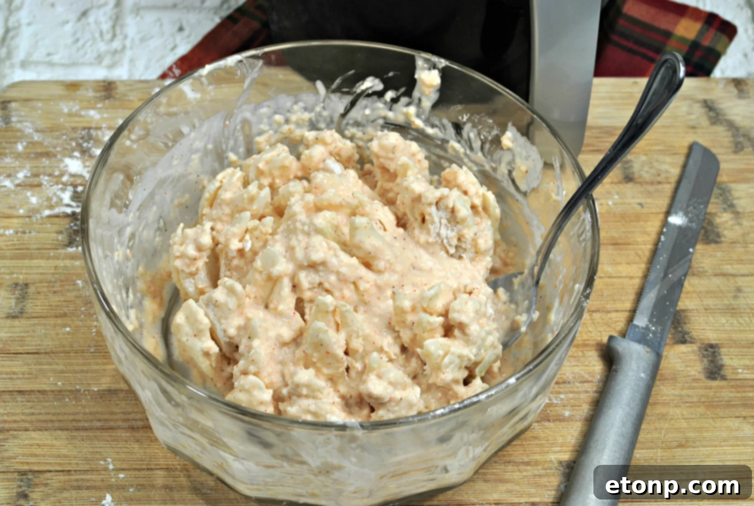 Bloomin' Onion being fully coated in batter and breadcrumbs