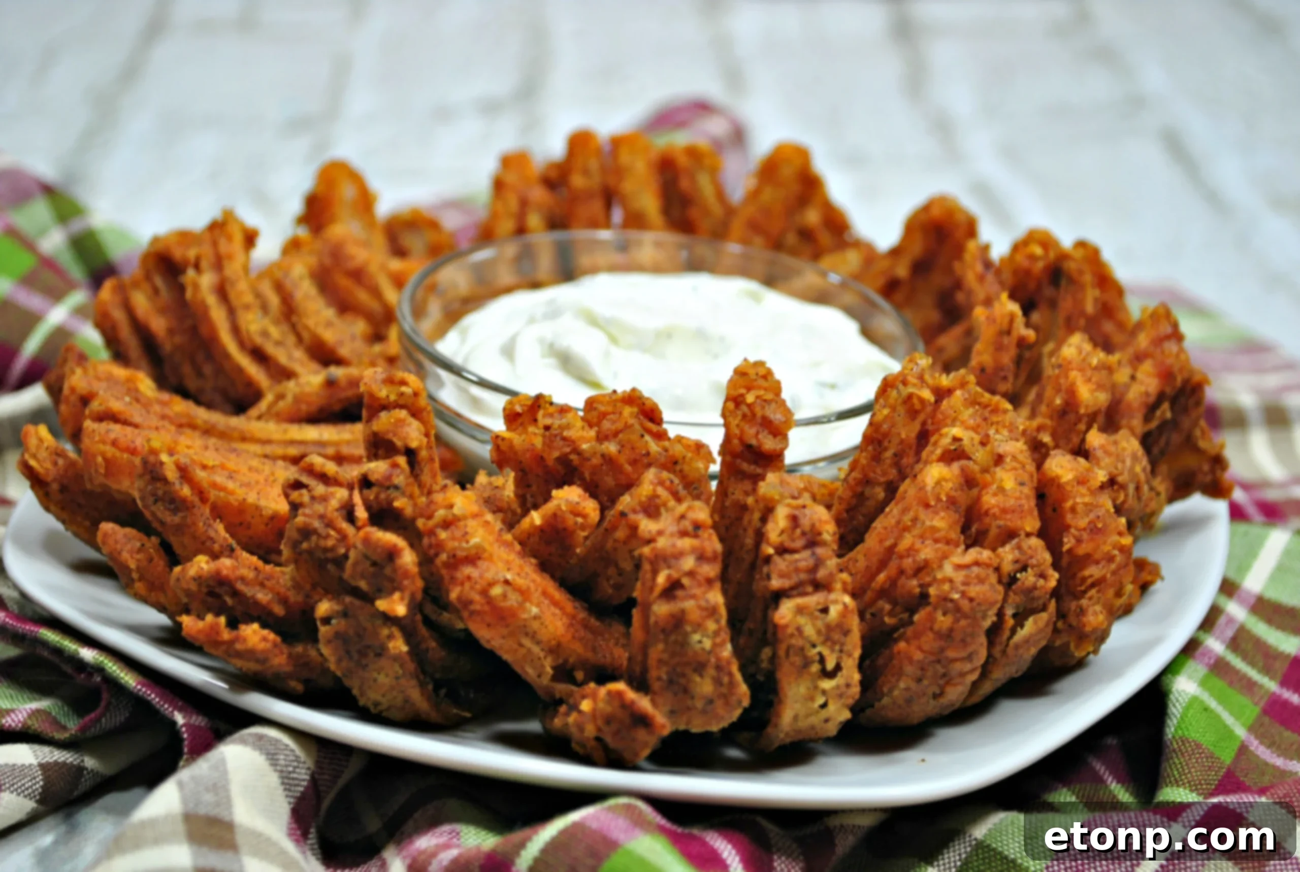 Close-up of a perfectly cooked Bloomin' Onion, ready to be dipped