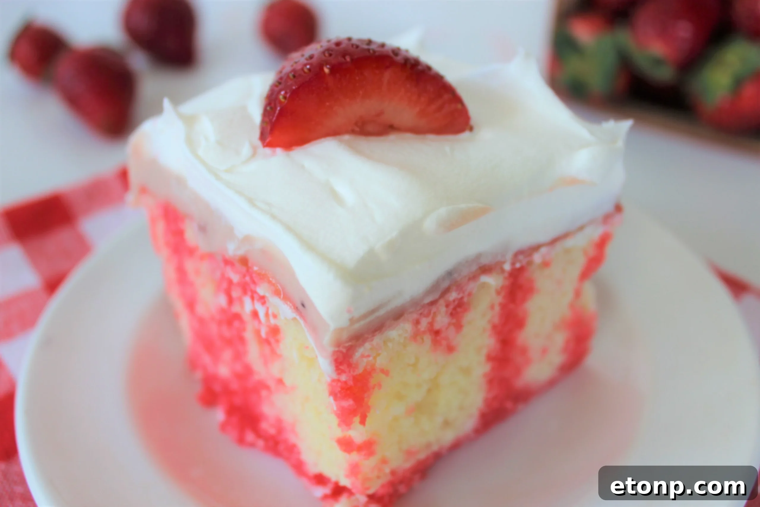 Irresistible Strawberry Cheesecake Poke Cake 2 Delicious slice of Strawberry Cheesecake Poke Cake with fresh strawberries