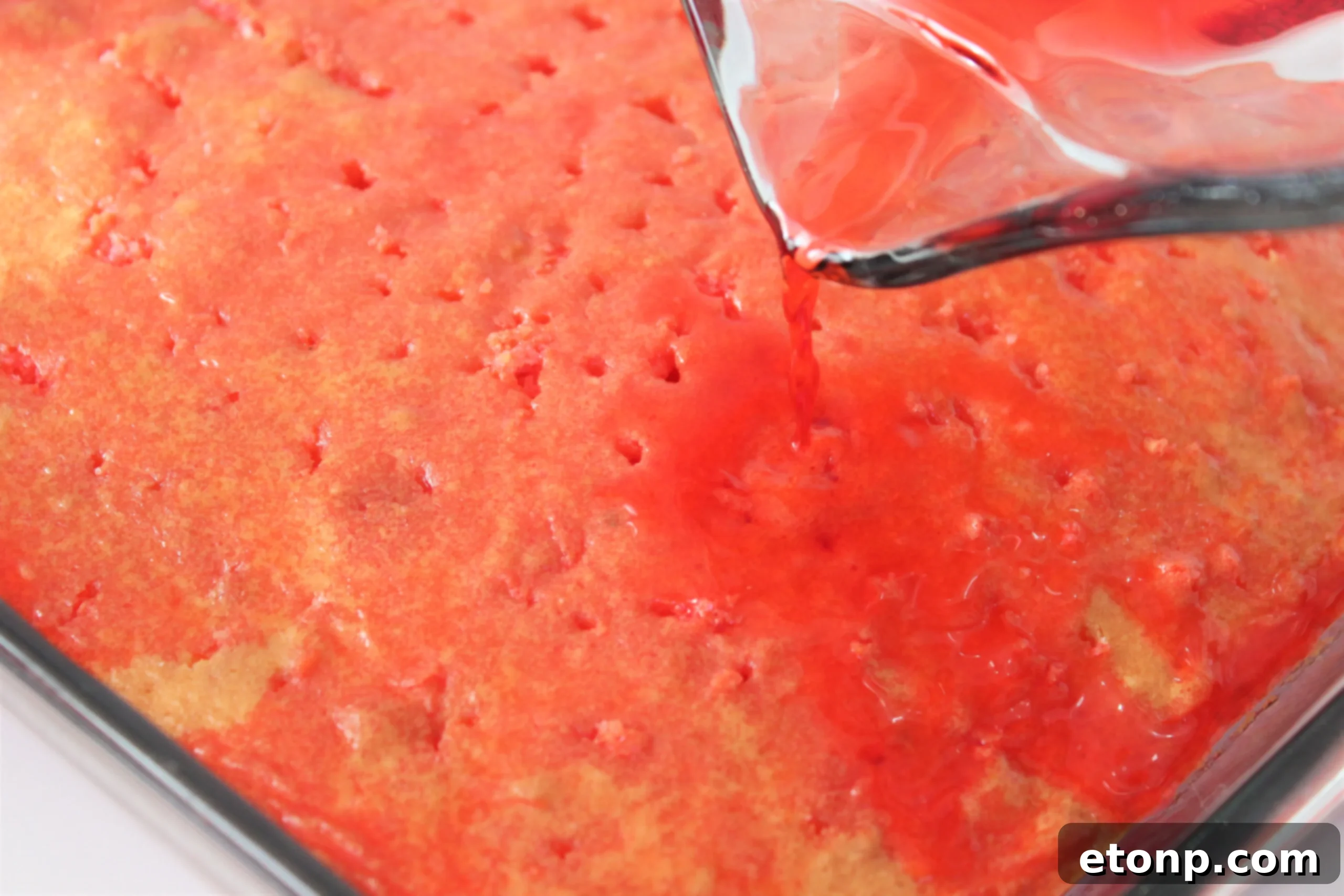 Irresistible Strawberry Cheesecake Poke Cake 3 Close-up of Strawberry Cheesecake Poke Cake showing layers
