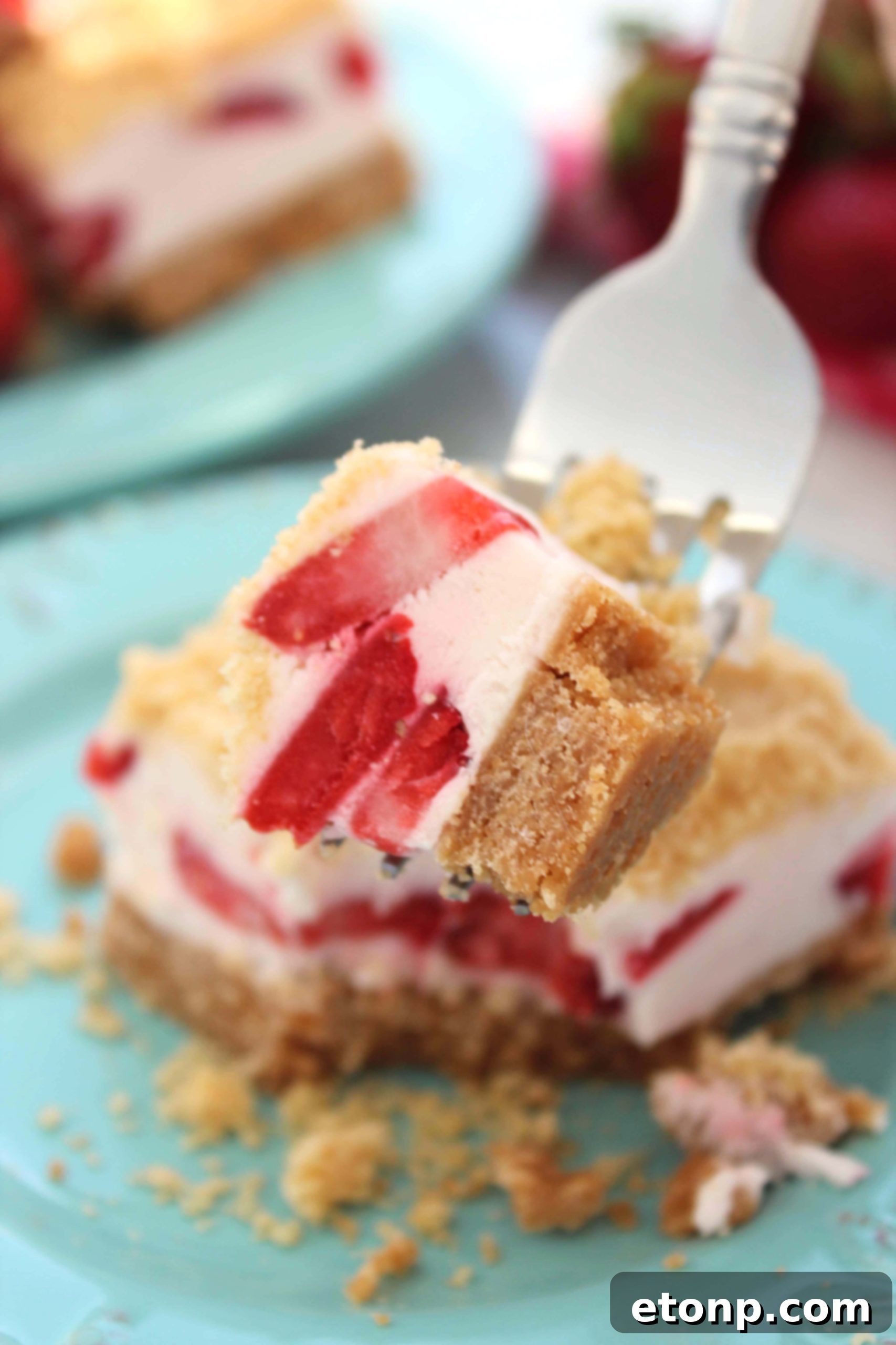 A stack of perfectly cut Strawberry Dream Sugar Cookie Bars arranged on a rustic cutting board, ready for serving