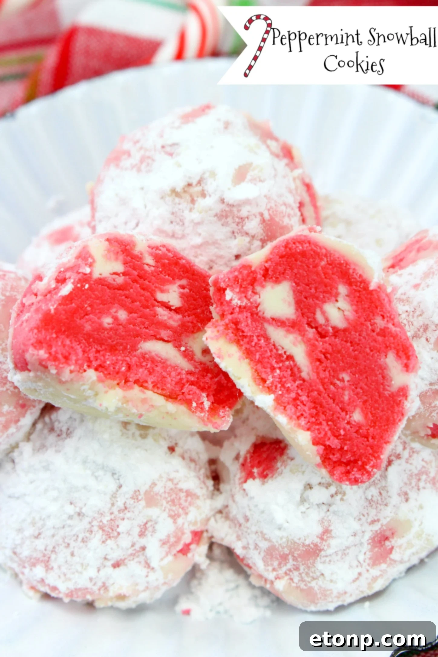 Delicious peppermint shortbread snowball cookies coated in powdered sugar, ready for the holidays.