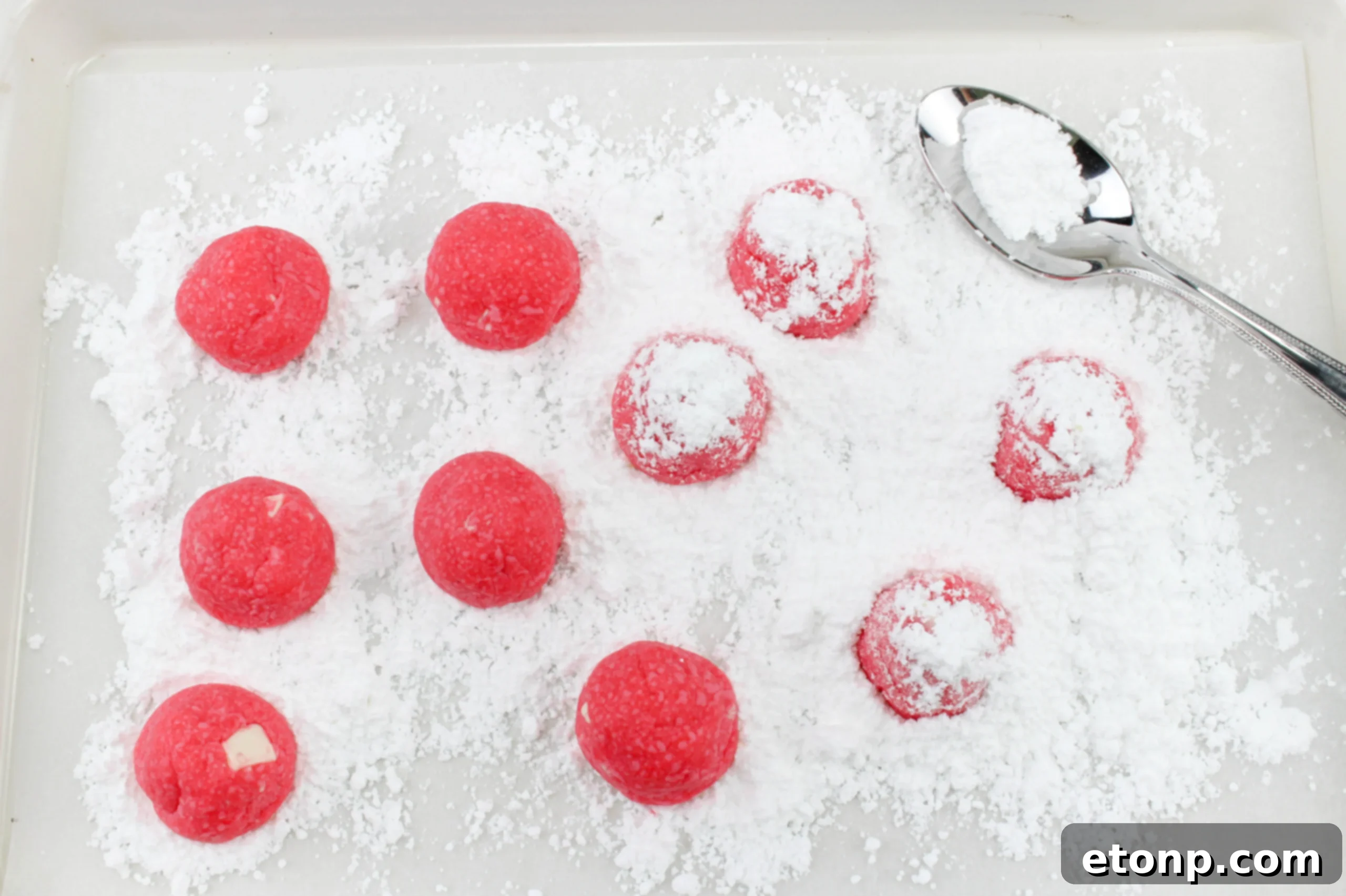 A festive spread of snowball cookies, highlighting their perfect round shape and snowy coating.
