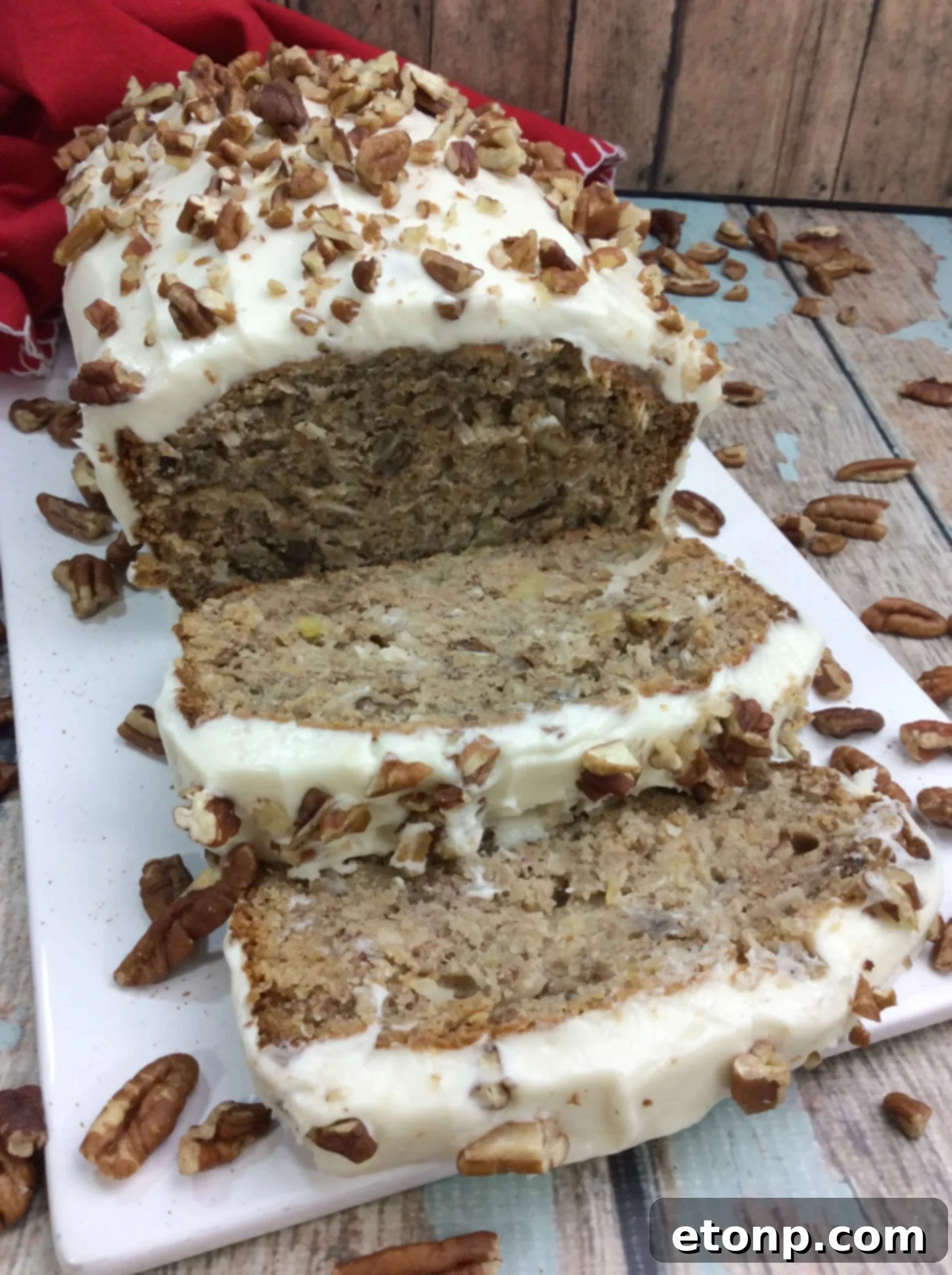 Delicious slice of Southern Hummingbird Bread with cream cheese frosting, ready to be enjoyed.