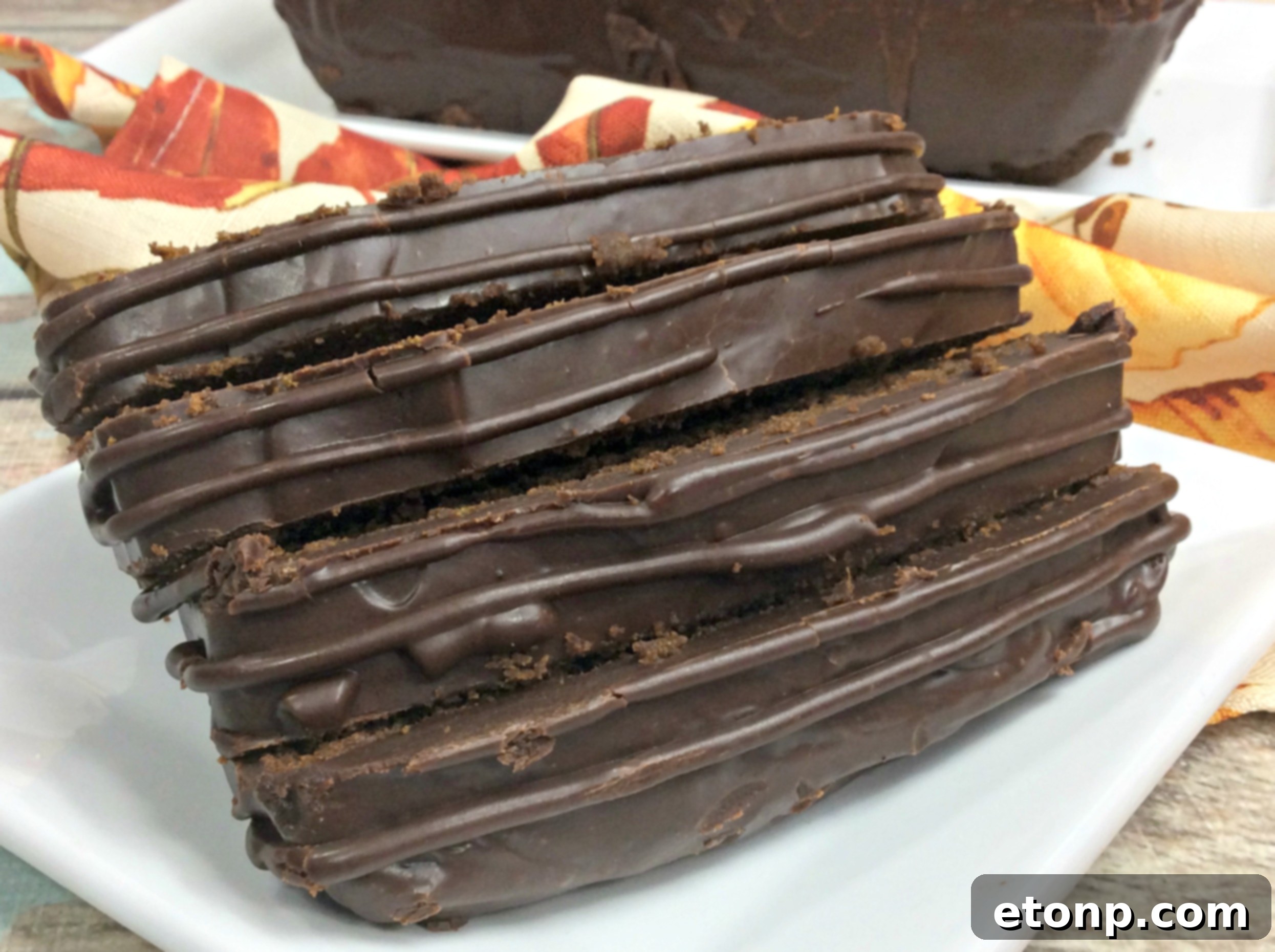Overhead shot of two loaves of chocolate pumpkin bread, one with ganache