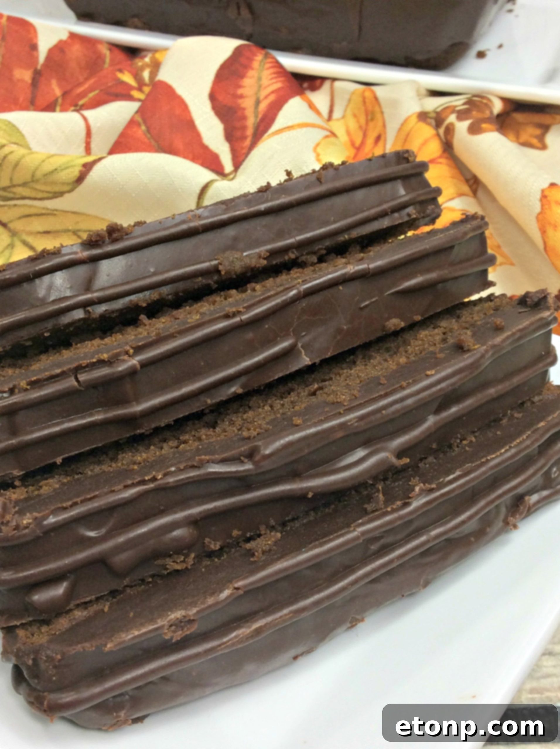 Beautifully glazed chocolate pumpkin pound cake on a cooling rack