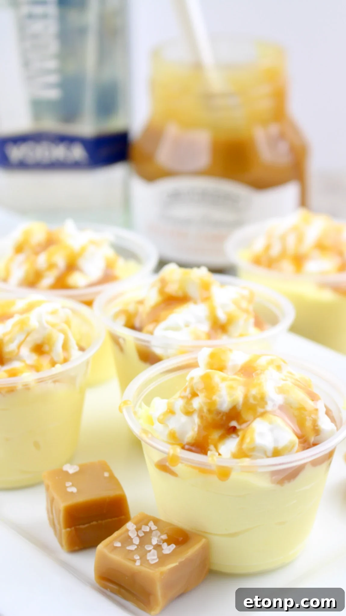 Final presentation of garnished Salted Caramel Pudding Shots on a dark background