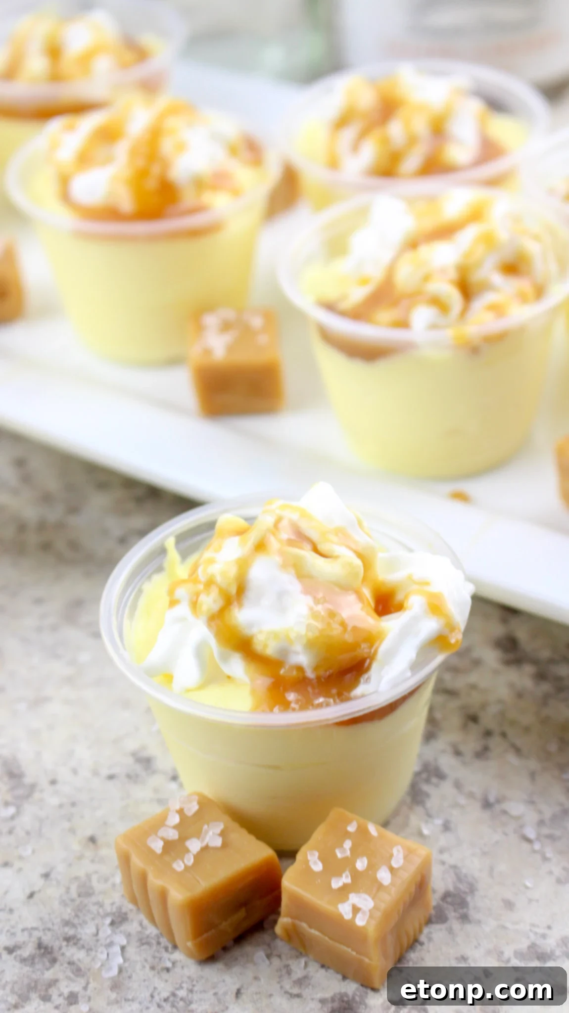 Hand holding a Salted Caramel Pudding Shot, showing texture