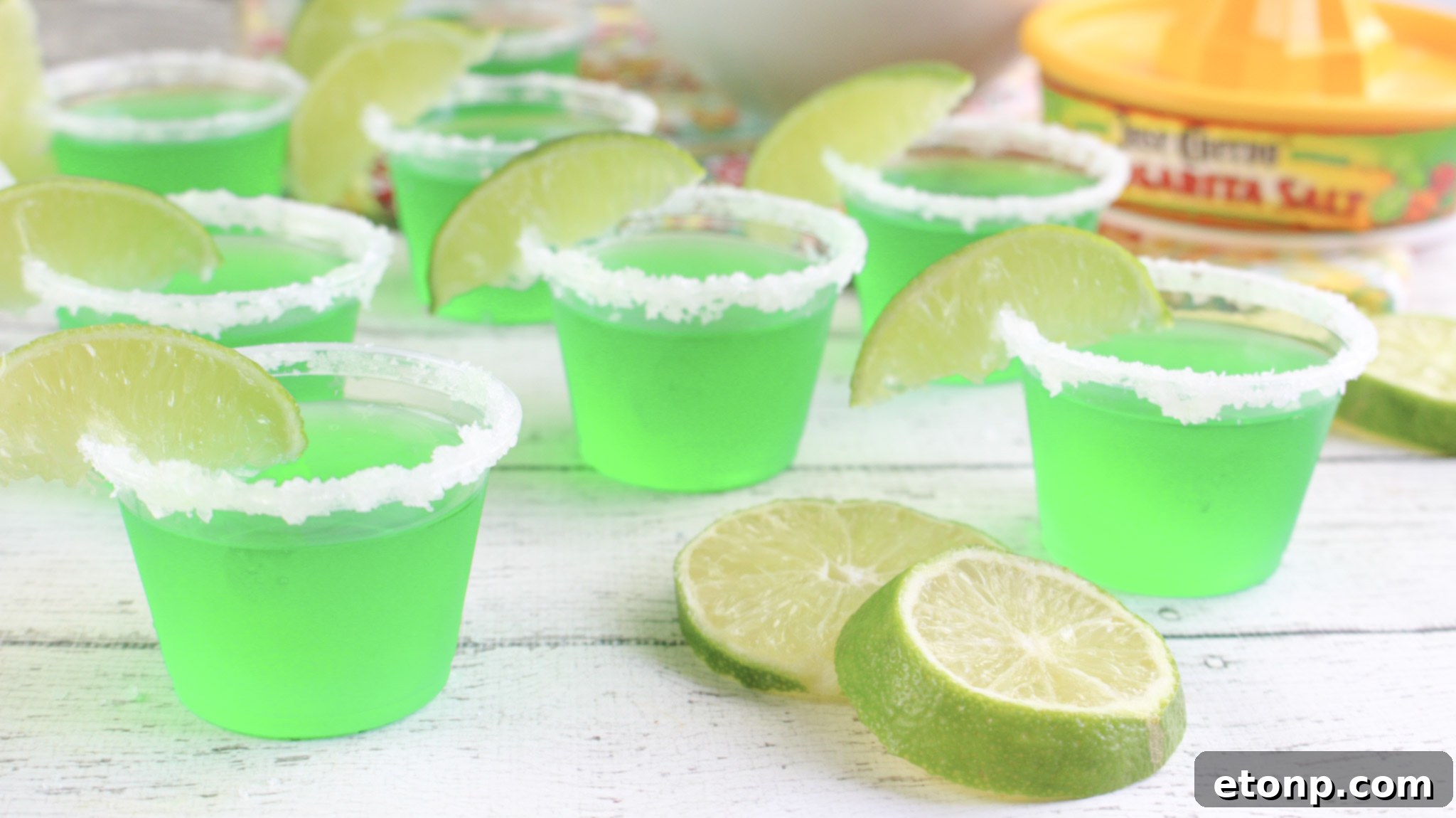 Margarita Jello Shots 9 Close-up of three Margarita Jello Shots with various garnishes, including lime wedges and different rim treatments.