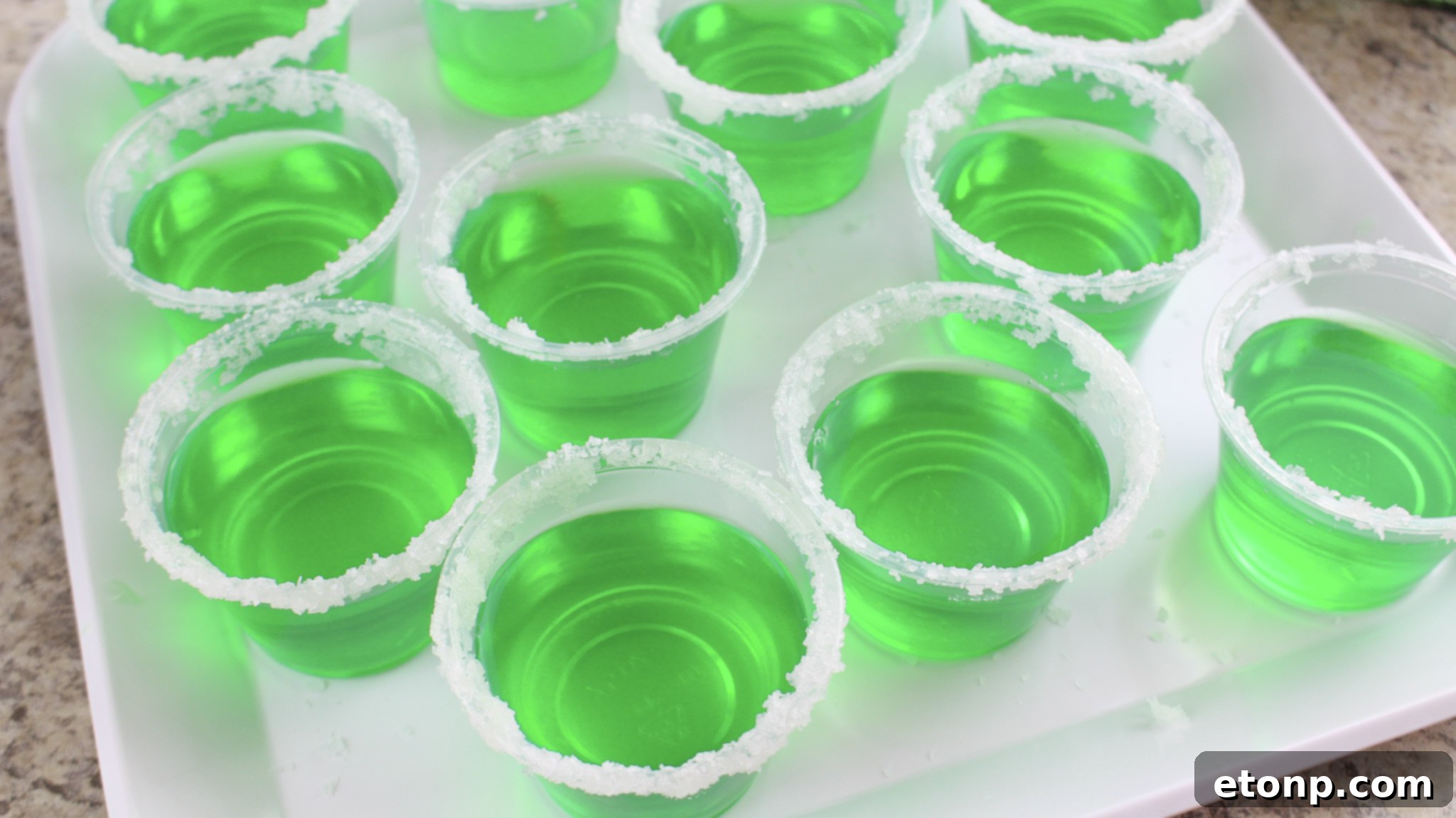 Margarita Jello Shots 10 A festive table setting featuring Margarita Jello Shots and other party snacks, highlighting their role in celebrations.
