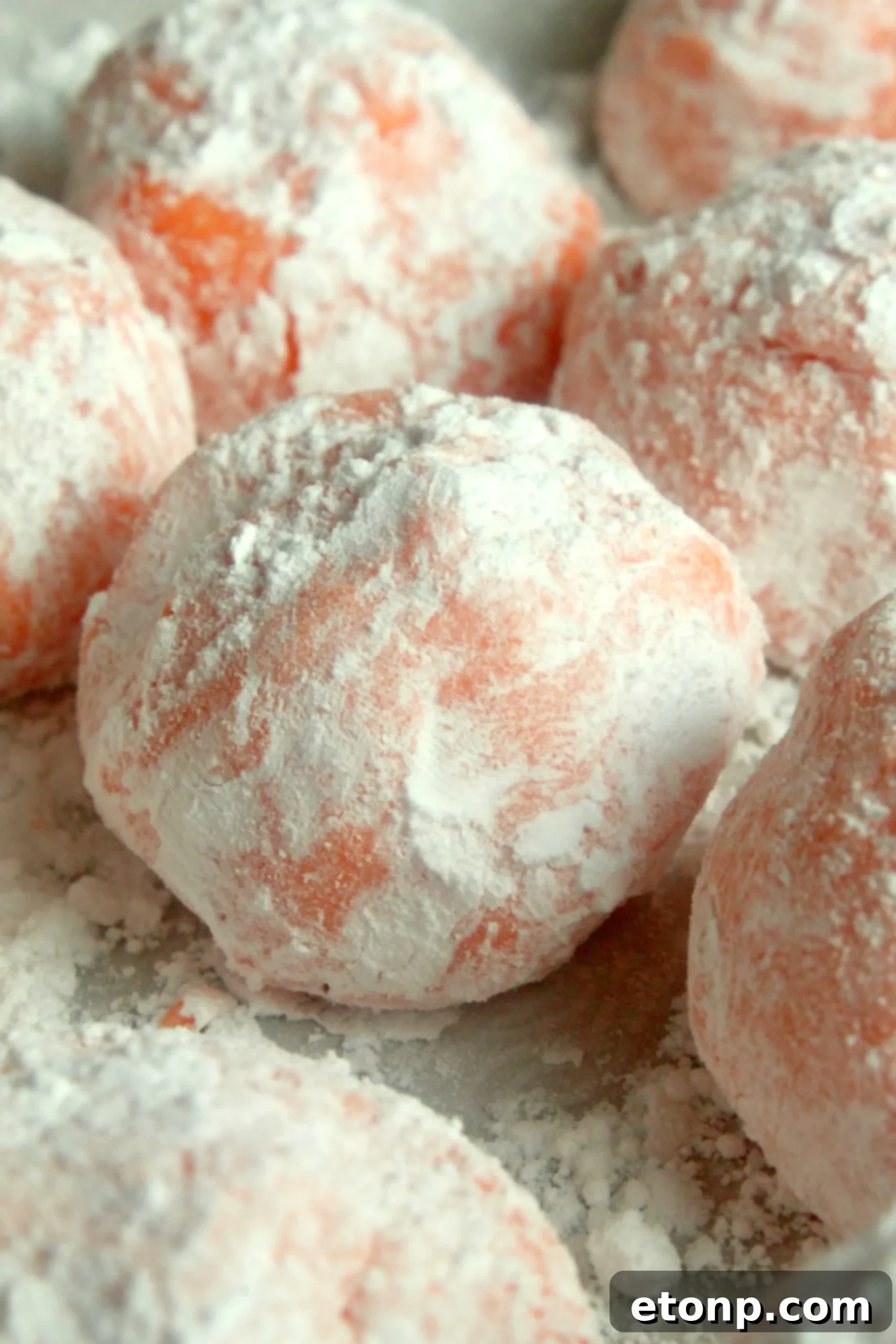 A close-up of the delicate texture of a No-Bake Orange Creamsicle Truffle, highlighting its soft coating