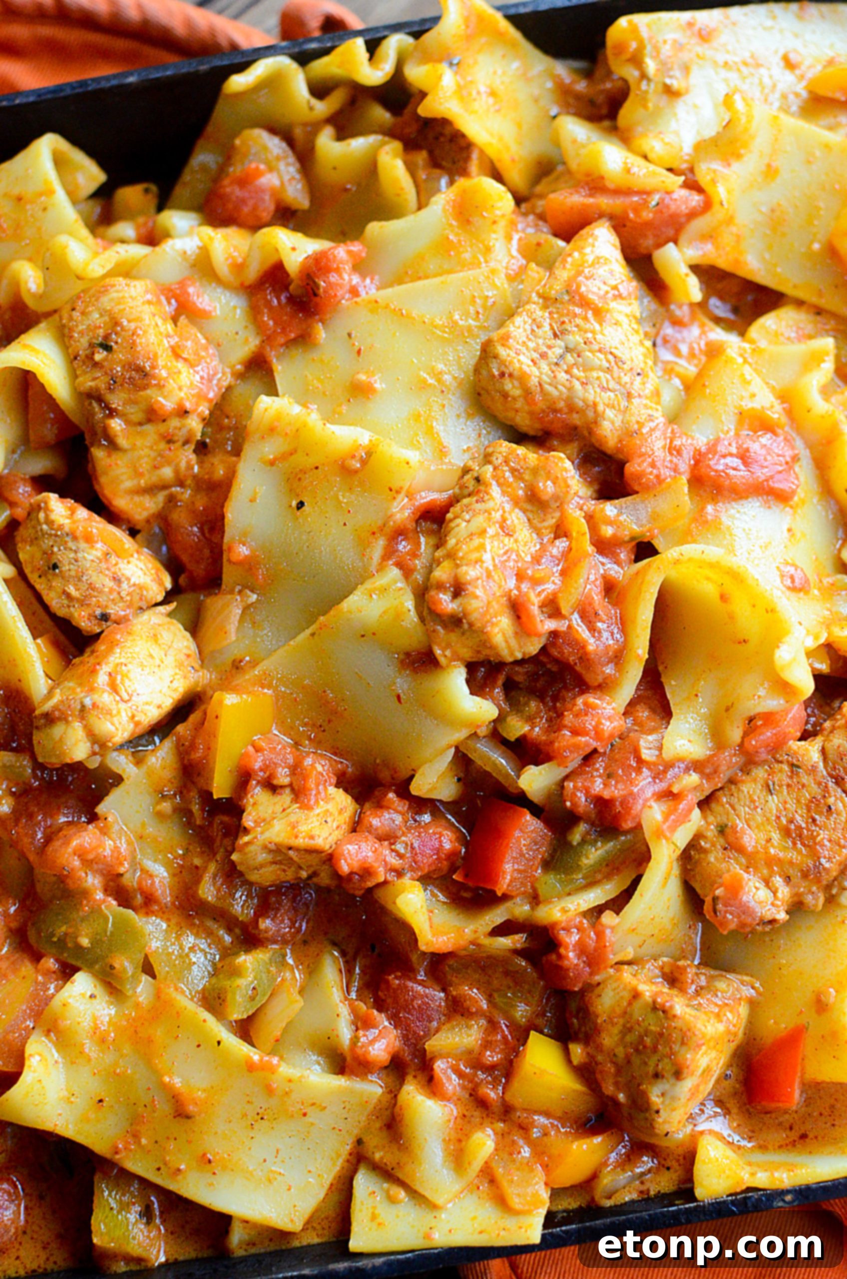Creamy chicken fajita pasta in a bowl with a fork, ready to eat