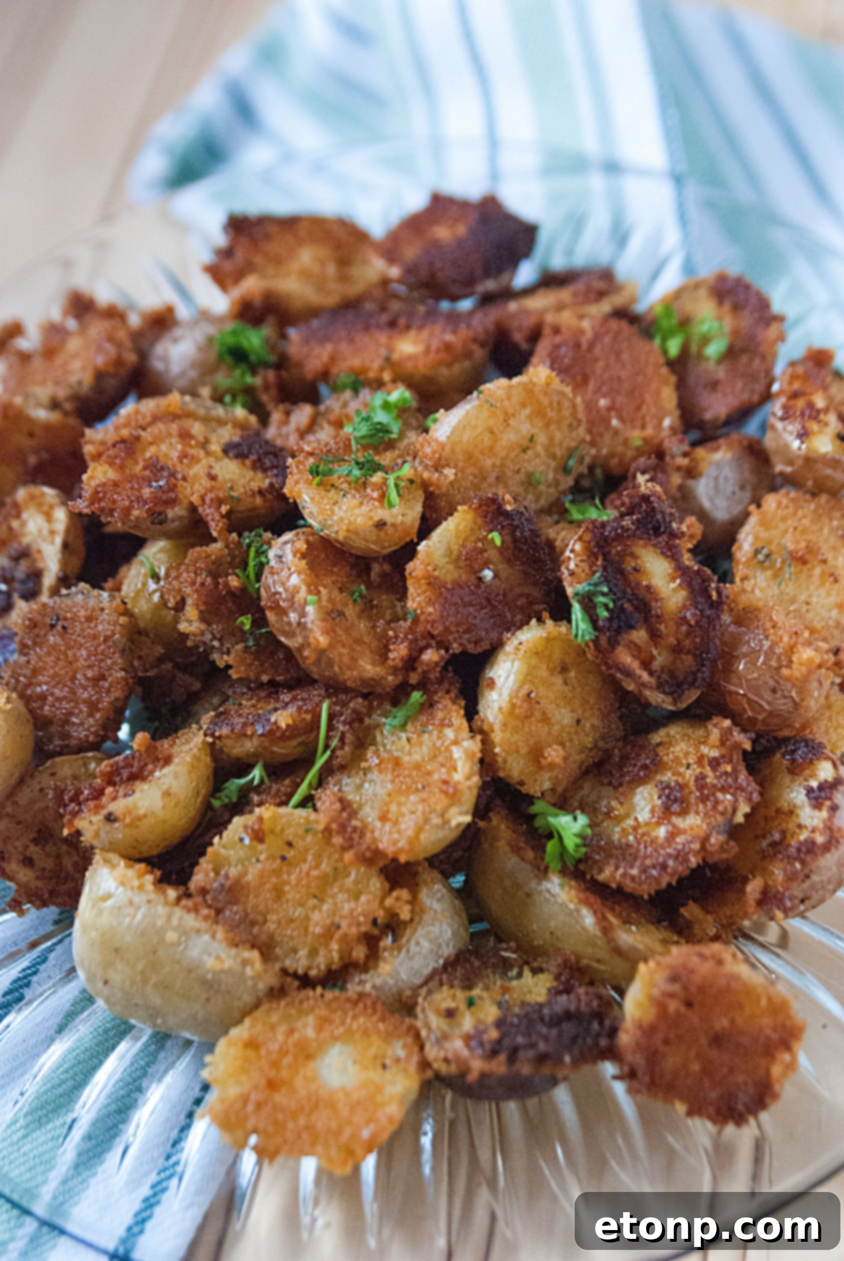 Serving crispy garlic parmesan potatoes in a dish