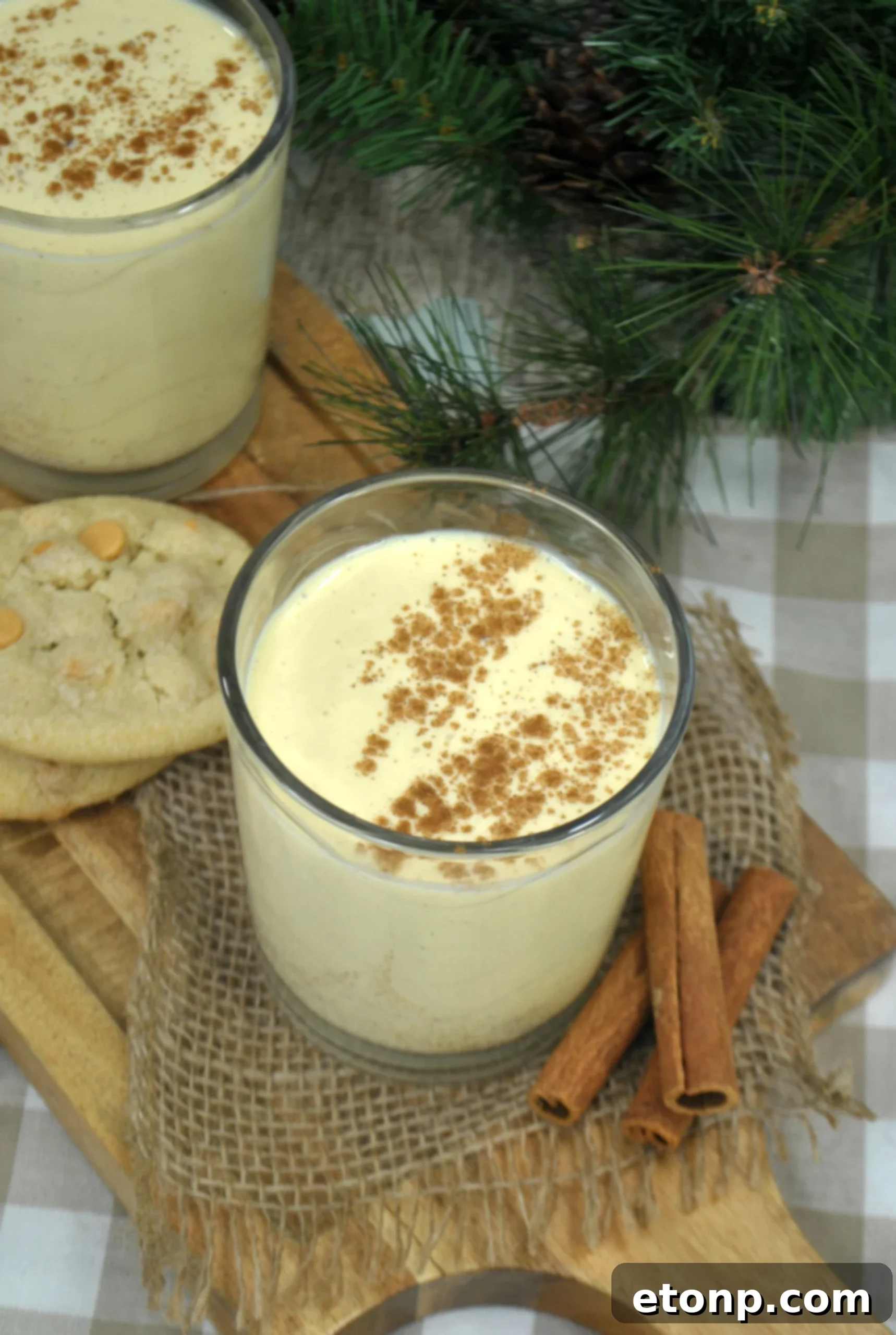 Classic Homemade Eggnog 3 A selection of fresh ingredients for homemade eggnog, including eggs, milk, sugar, vanilla, and whole nutmeg, artfully arranged on a rustic kitchen counter, ready for preparation.