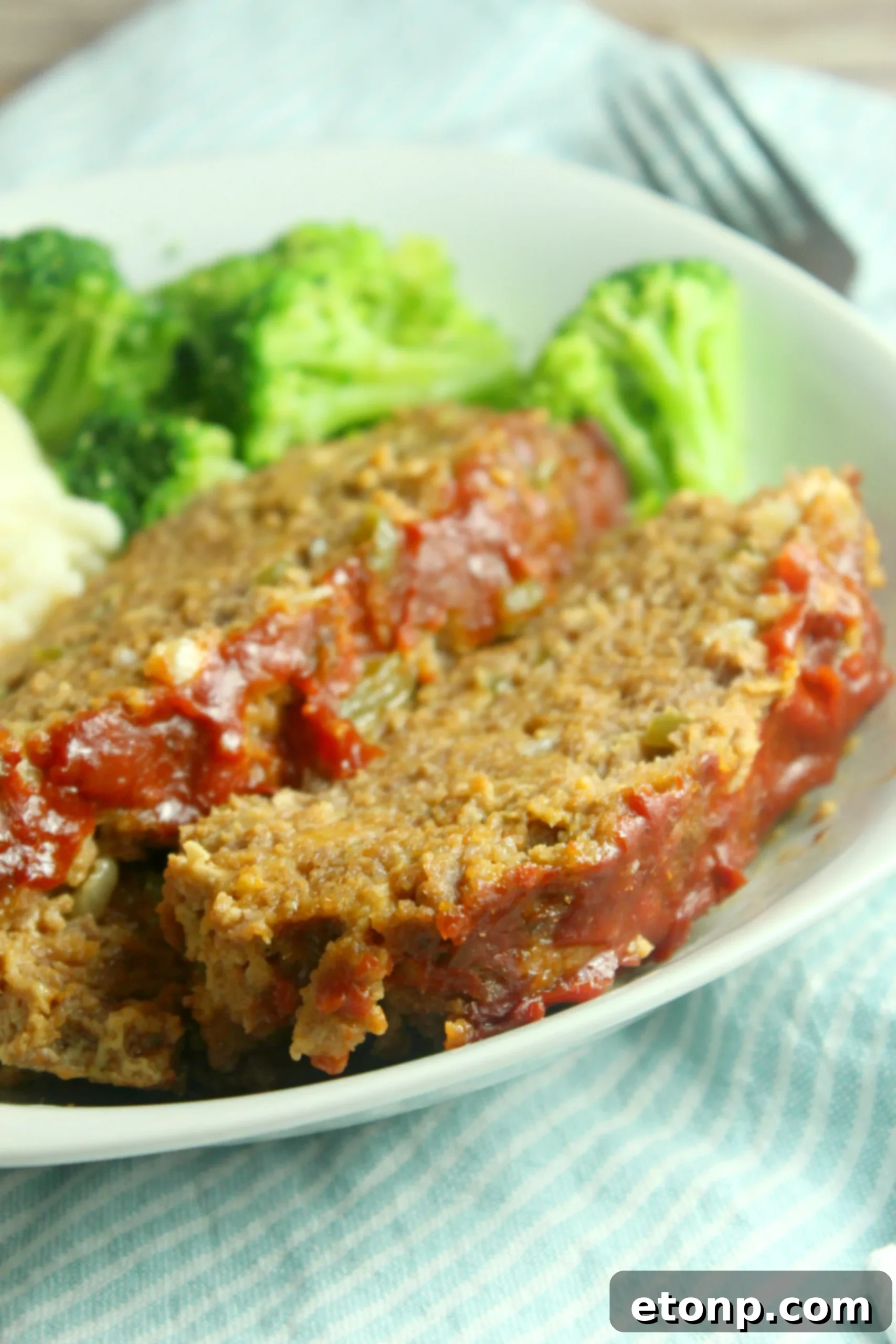 Delicious slow cooker meatloaf, freshly cooked and ready to serve on a plate.