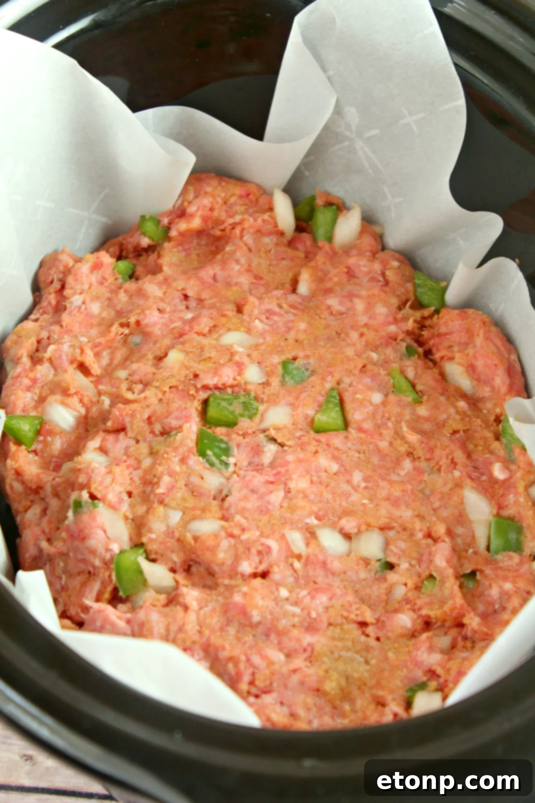 Perfectly formed slow cooker meatloaf, ready for cooking in a crock-pot liner.