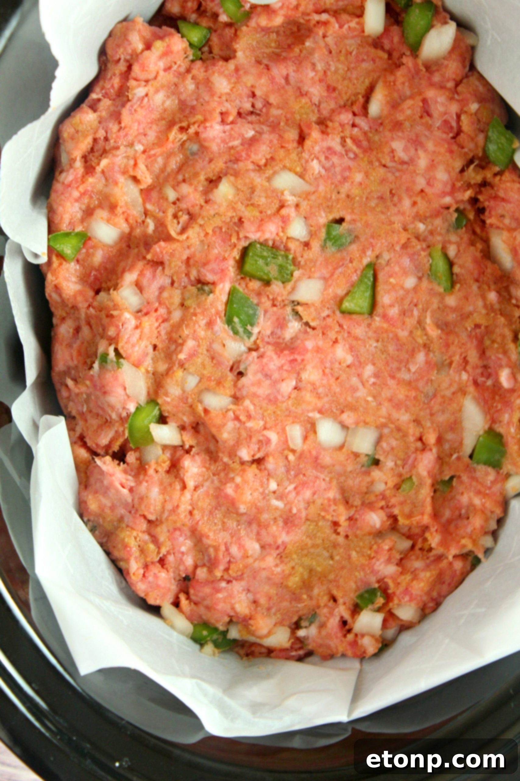 Meatloaf cooking in a slow cooker, showing the convenient liner for easy cleanup.