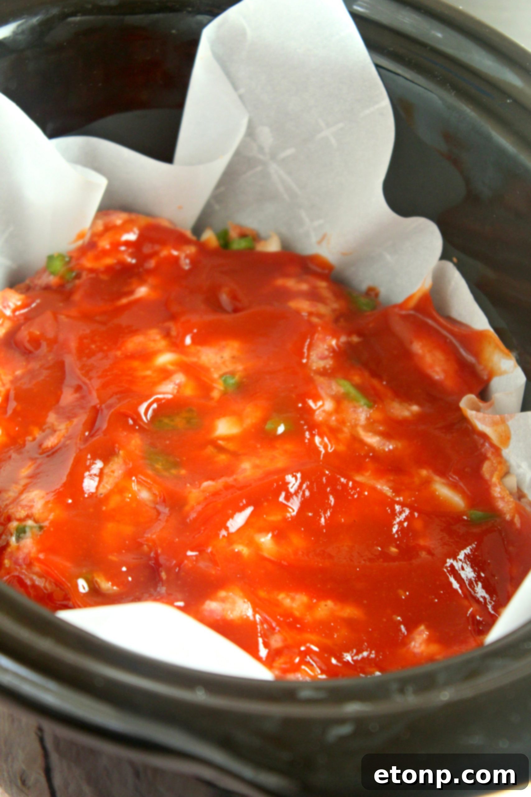 Meatloaf topped with a rich ketchup glaze, a classic comfort food ready to serve.