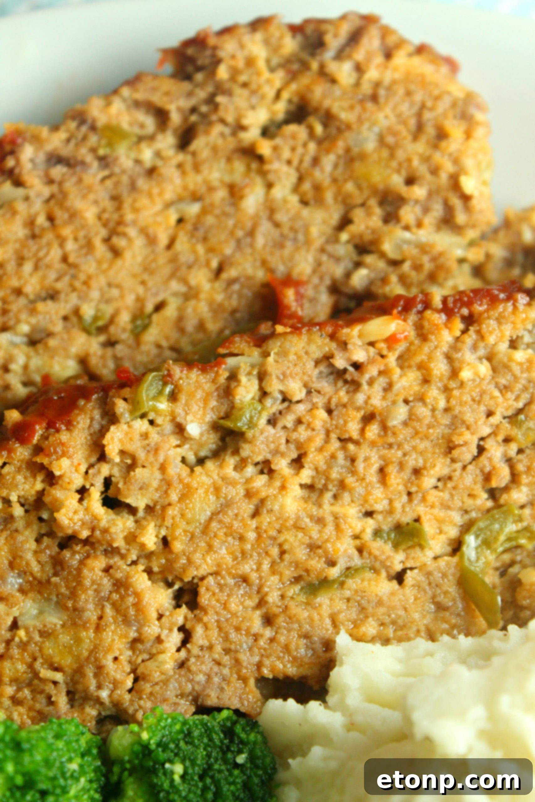 Hearty slice of slow cooker meatloaf, promising a comforting and delicious meal.
