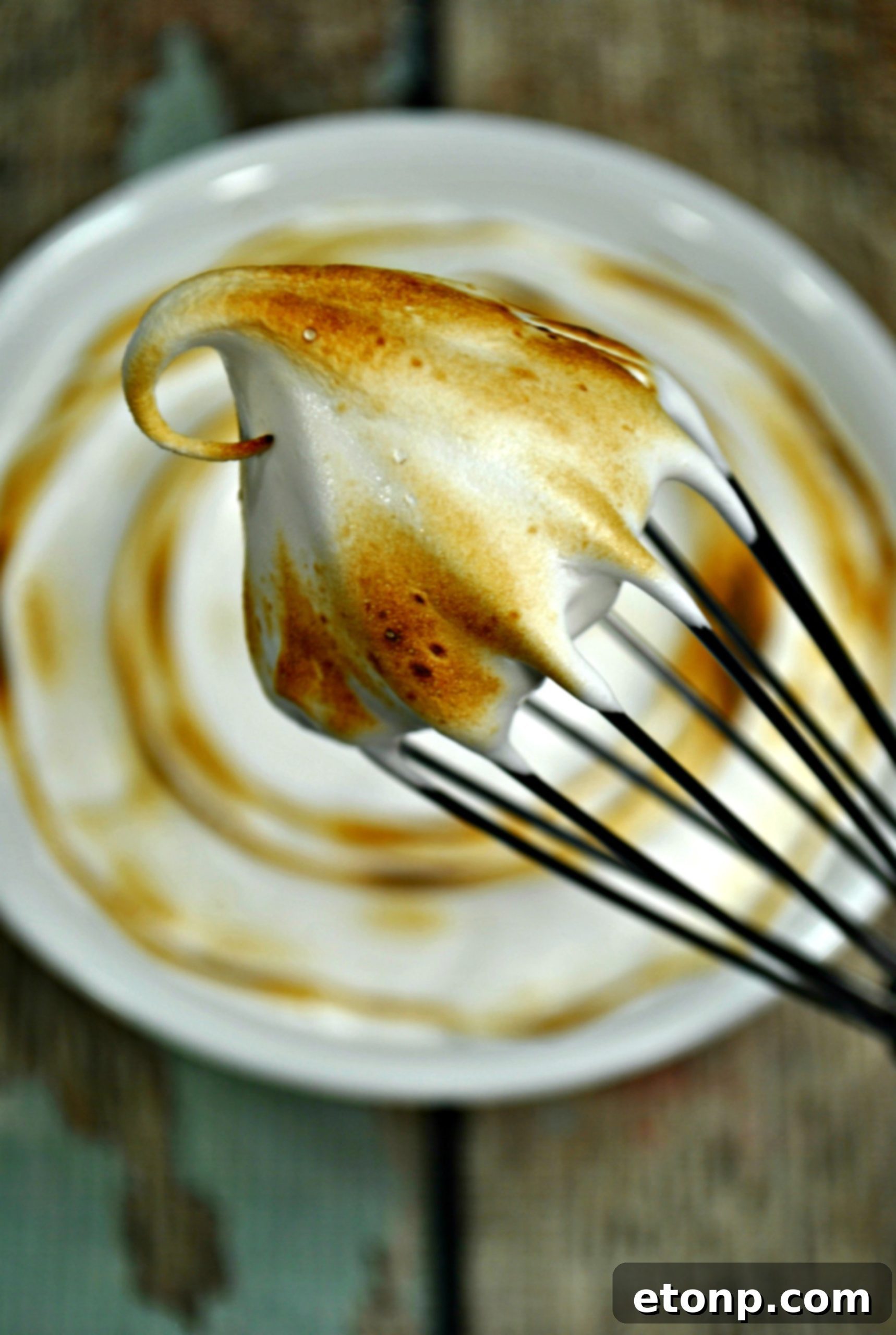 Toasting marshmallow frosting with a kitchen torch