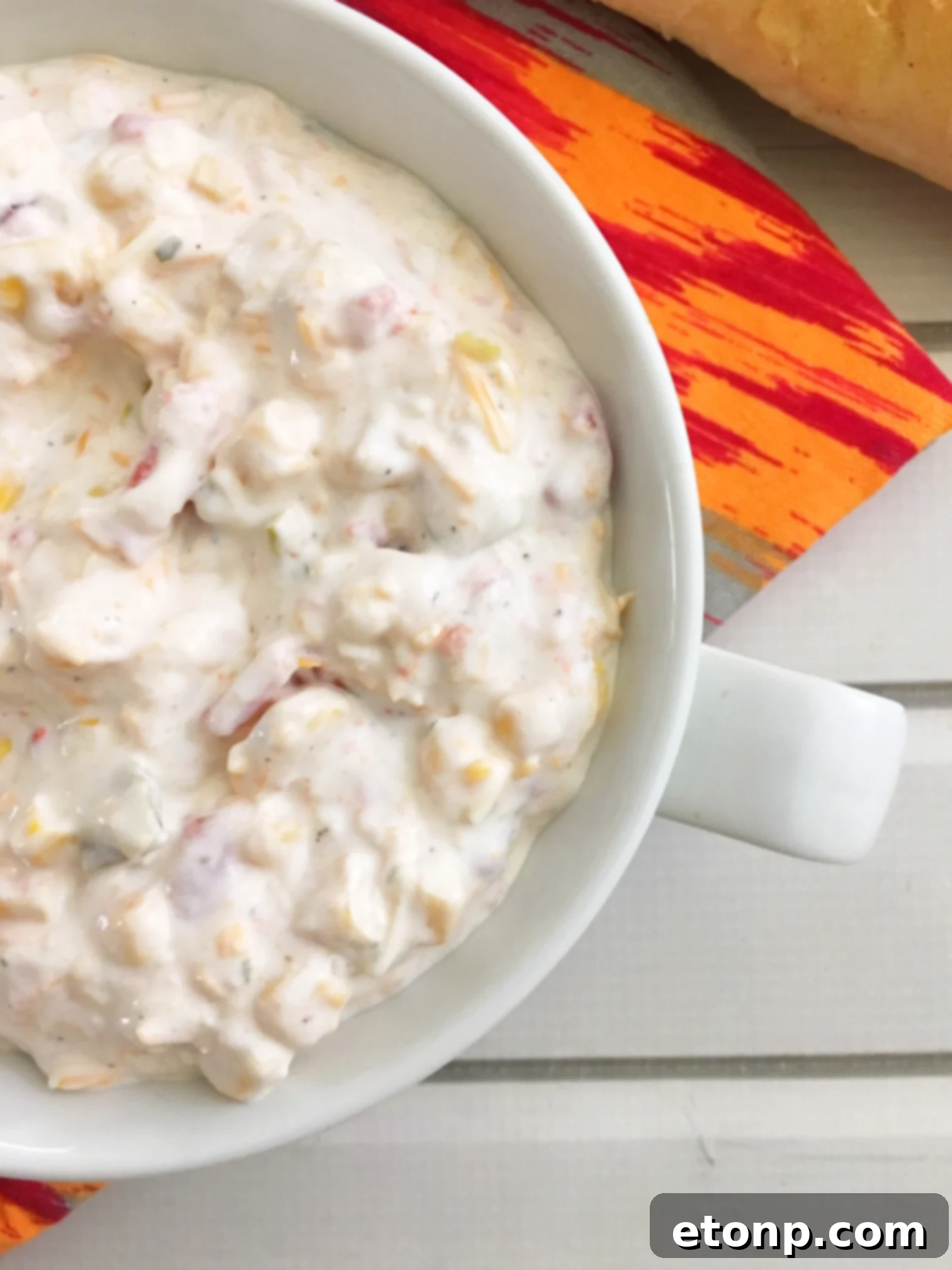 Fiesta dip served with a variety of dippers including chips, crackers, and vegetables