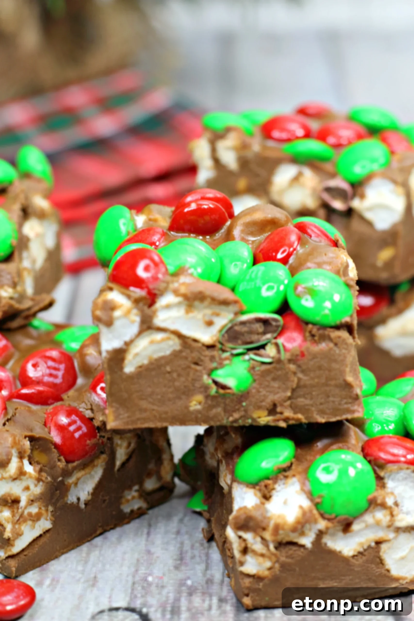 A stack of beautifully presented no-bake holiday marshmallow bars, perfect for a dessert plate.