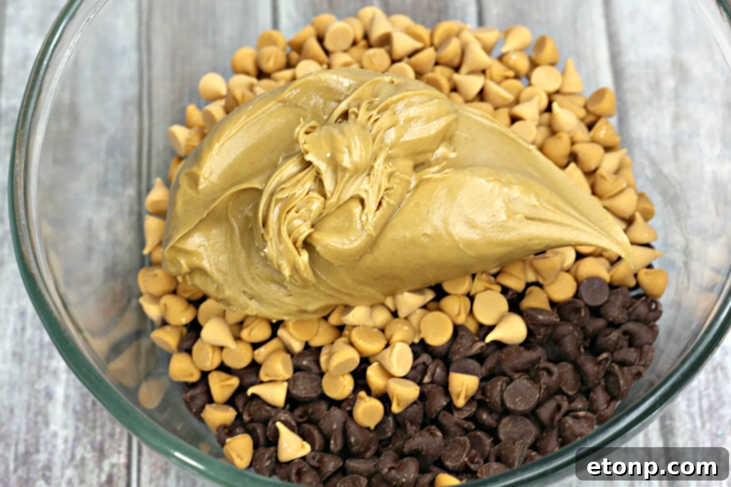Bowl of melted chocolate, butterscotch, and peanut butter before adding marshmallows.