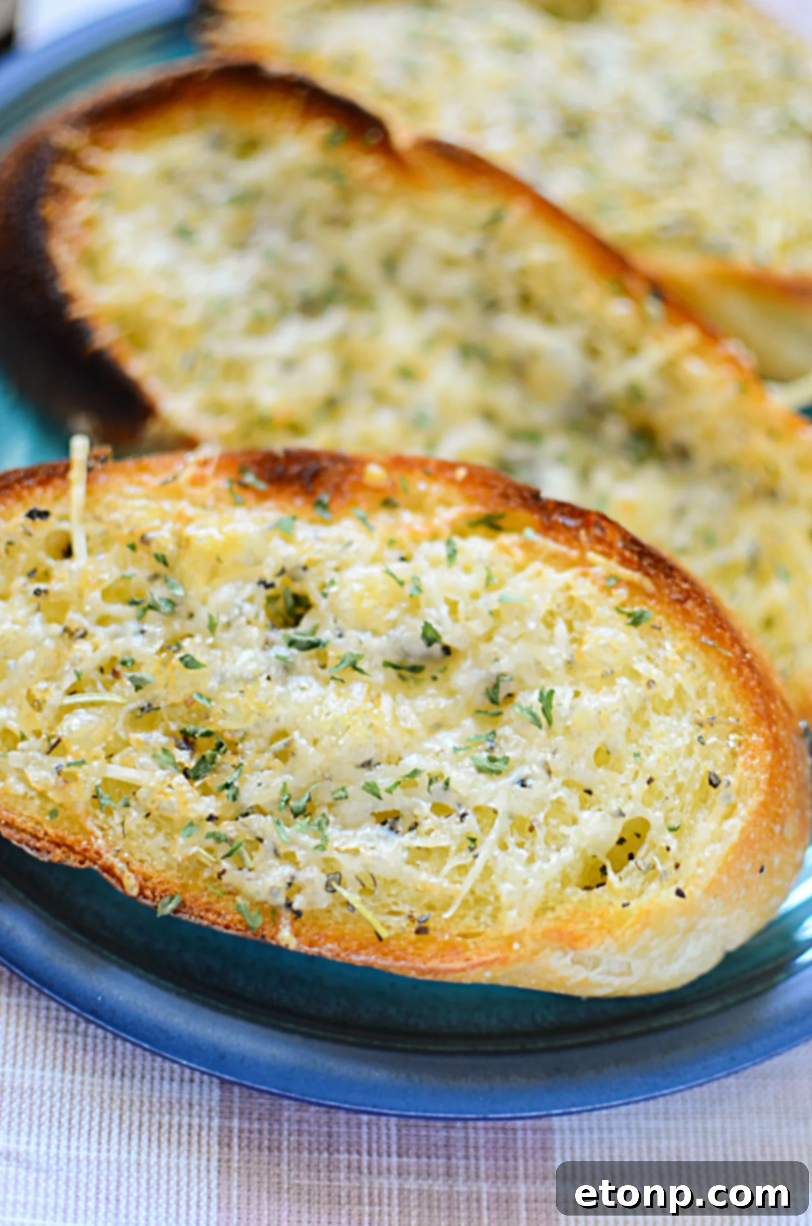 Crispy golden brown garlic parmesan bread slices, ready to serve.