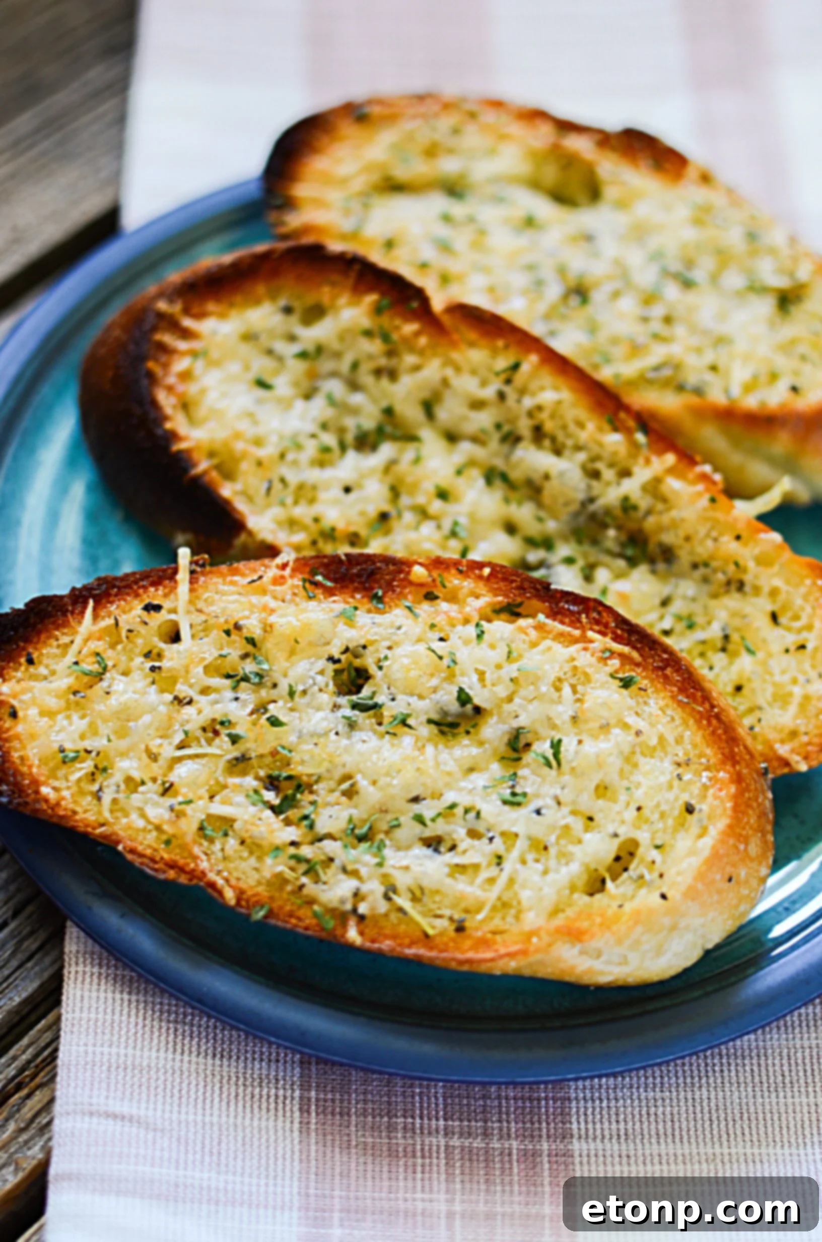 Platter of garlic parmesan bread, some with toppings, ready for serving.